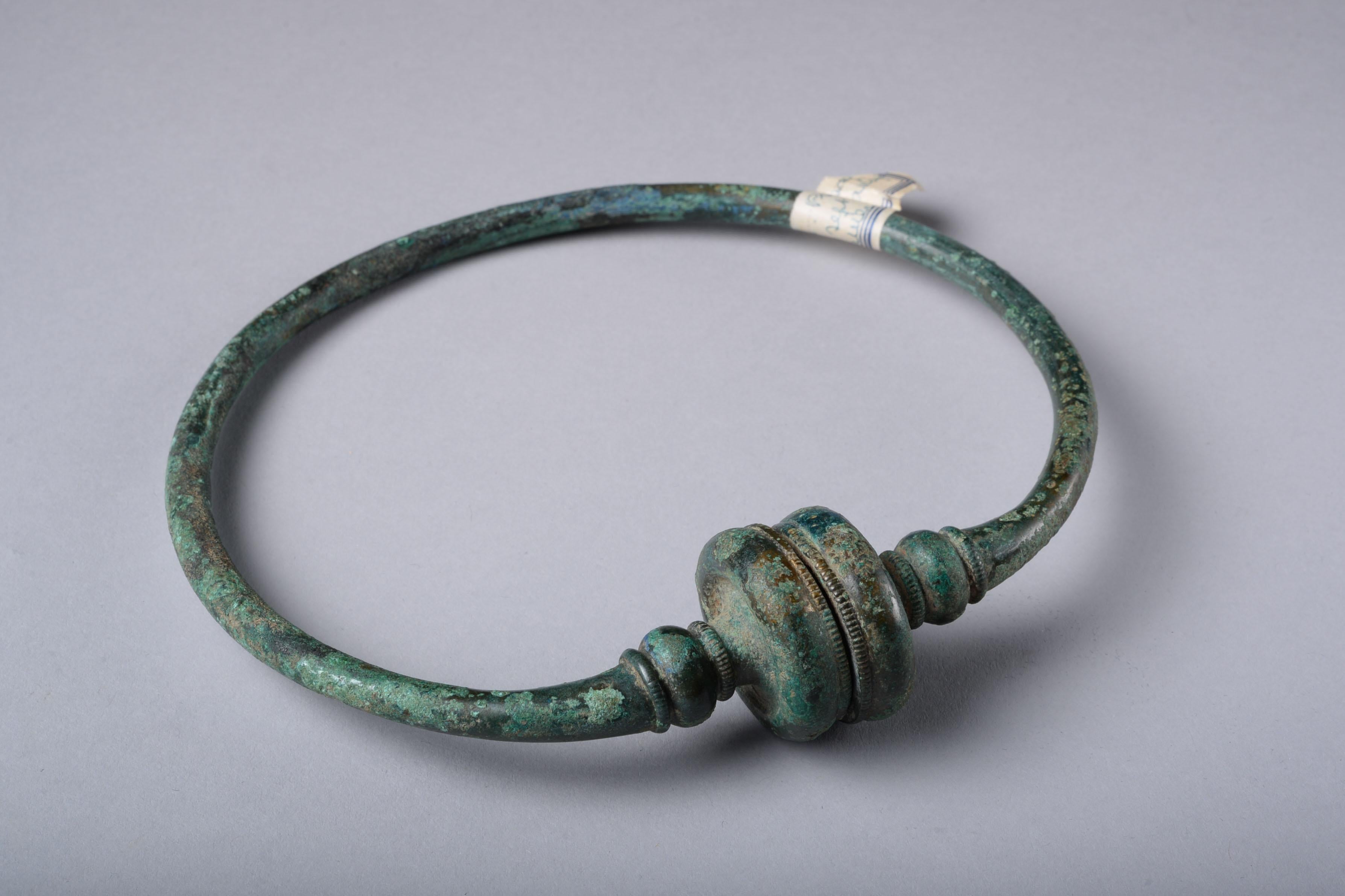 Celtic La Tène bronze torc, circa 350-150 BC.

With a circular hoop widening subtly at the front, two pronounced bands flanked by beaded collars, and with hollow terminals with notched sections.

Torcs were status objects worn around the neck by the