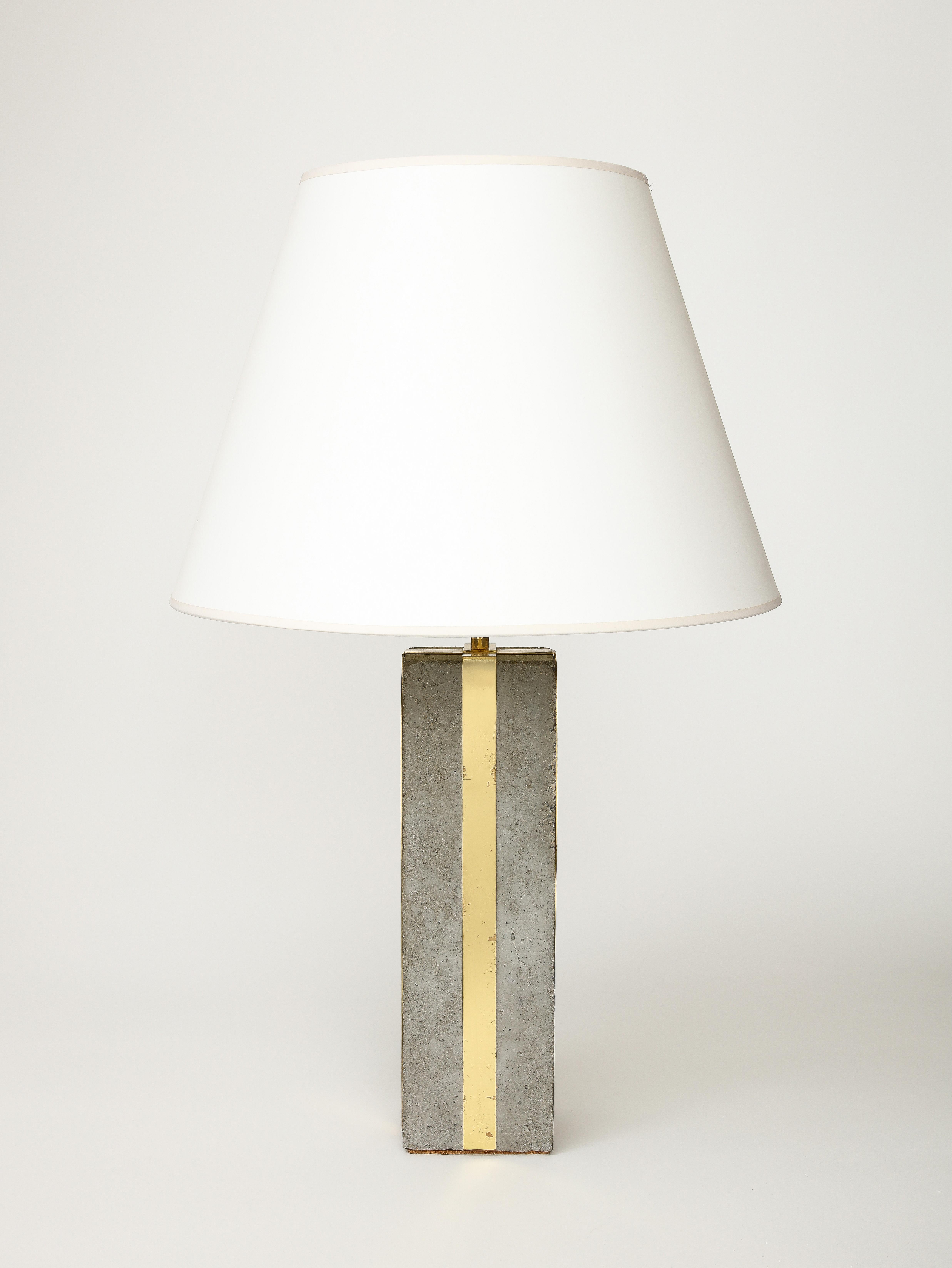 Strong, heavy table lamp by an unknown designer. The brass shines and contrasts beautifully with the raw concrete.

This table lamp was recently rewired with a black twisted silk cord, and bronze hardware.

Overall Height: 28