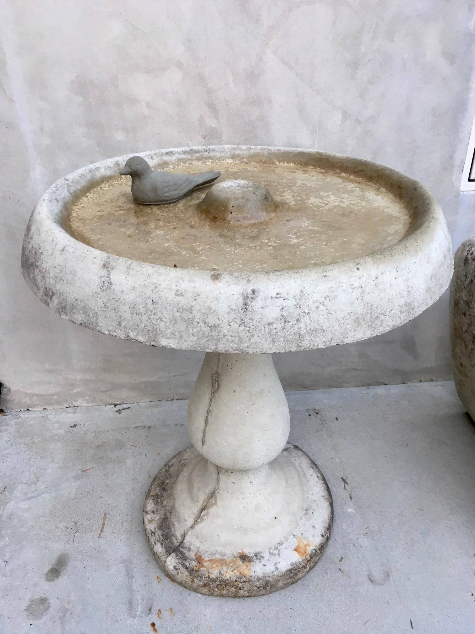 Gorgeous cement bird bath with cement bird. Round bowl sits atop pedestal base with moveable bird on top. Great vintage condition.