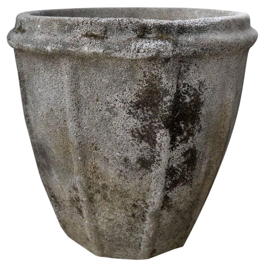 Purchased in France these cement planters created, circa 1950 have a beautiful patina showing a variety of grey tones and stoic decorative ribbing.