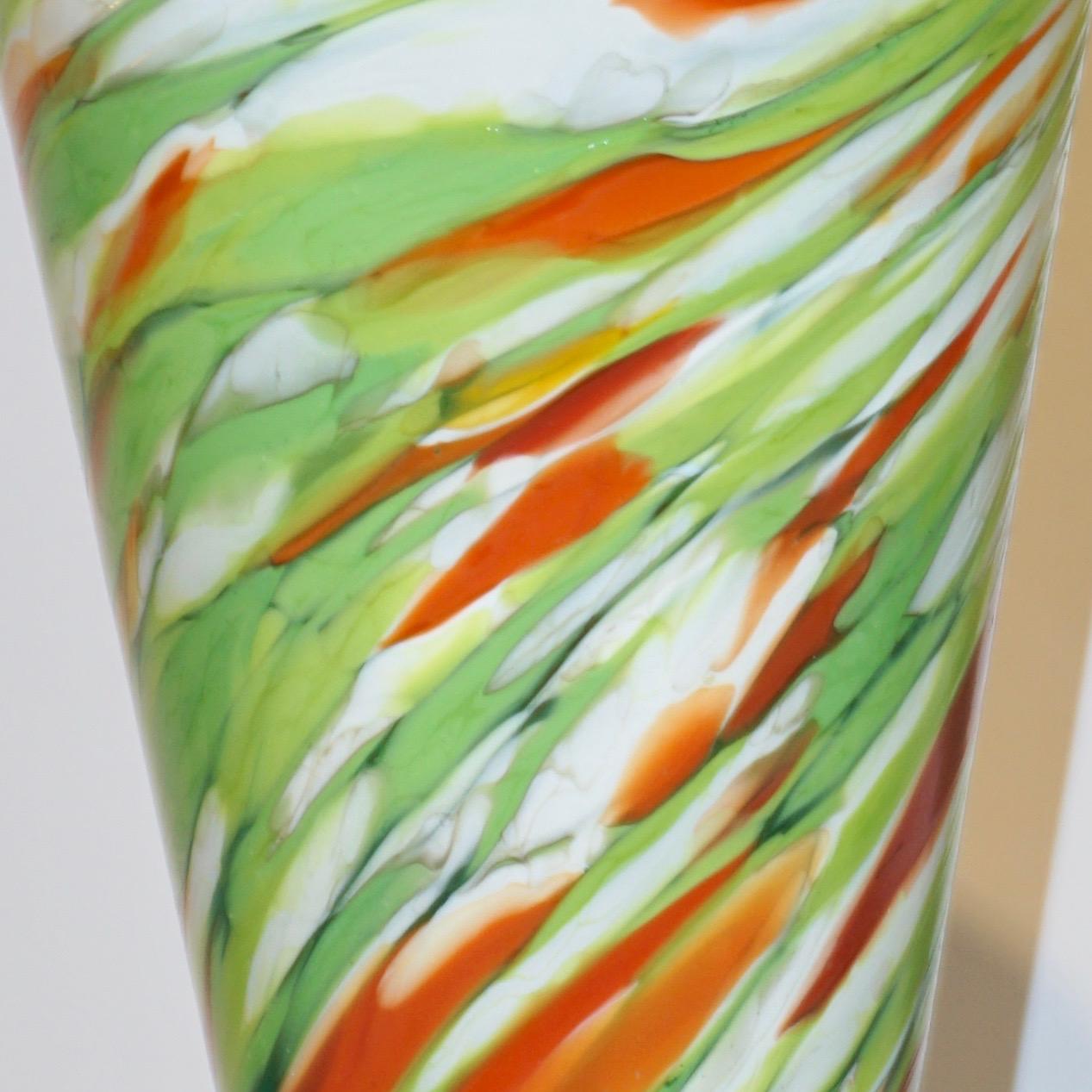 A striking vintage pair of modernist vases signed Cenedese, a colorful modern creation in Murano glass, precursor of the Memphis style, the conical shape is enhanced and decorated with swirls of murrine in vivid colors on white: sunburst orange and