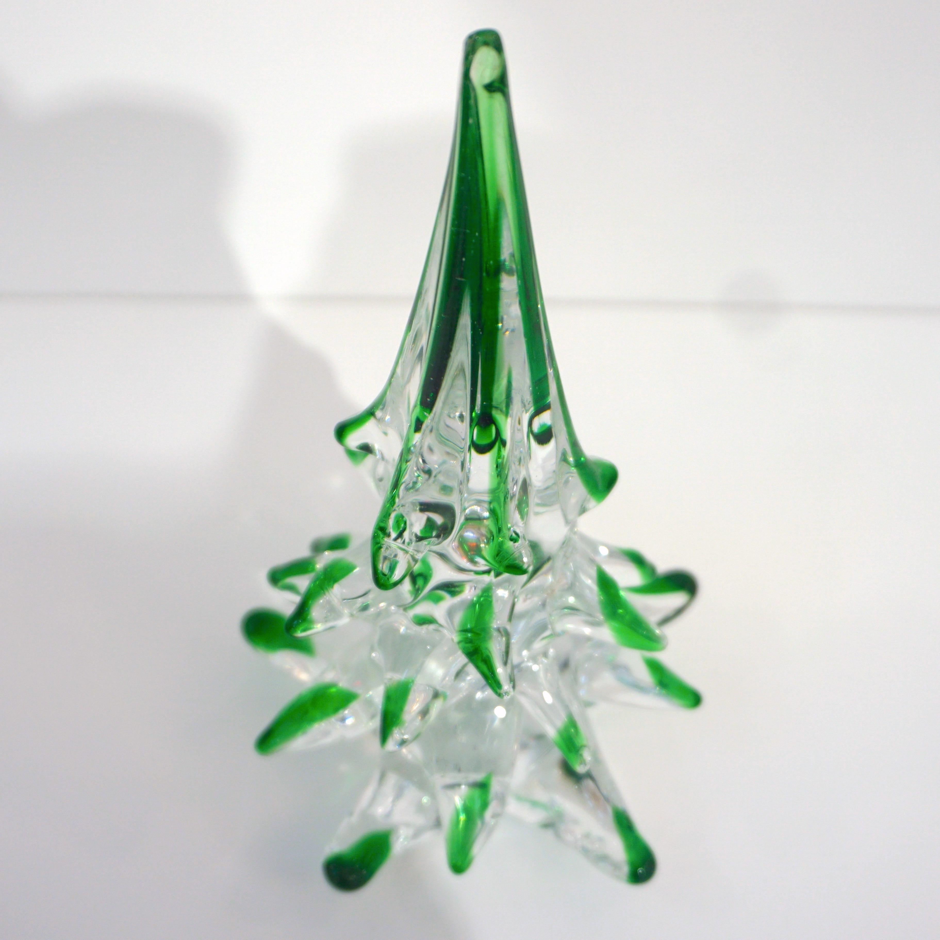 Murano glass tree of organic sleek modern design, a vintage creation signed by Cenedese Murano, individually mouth-blown and handcrafted. The crystal clear Murano glass is worked with the inclusion of forest green filigrana, glass colored canes, and