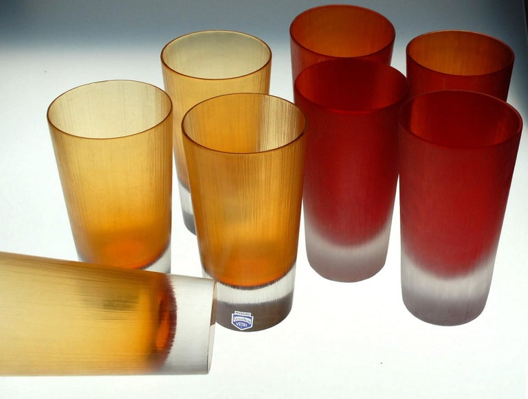 Great set of 4 amber and 4 red tumblers. Heavy glass Sommerso clear bottom over a deep amber or a dense red.
Amelio Cenedese here made tumblers borrowing Carlo Scarpa velati technique. These is made with a thin wheel grinding over the surface. It's