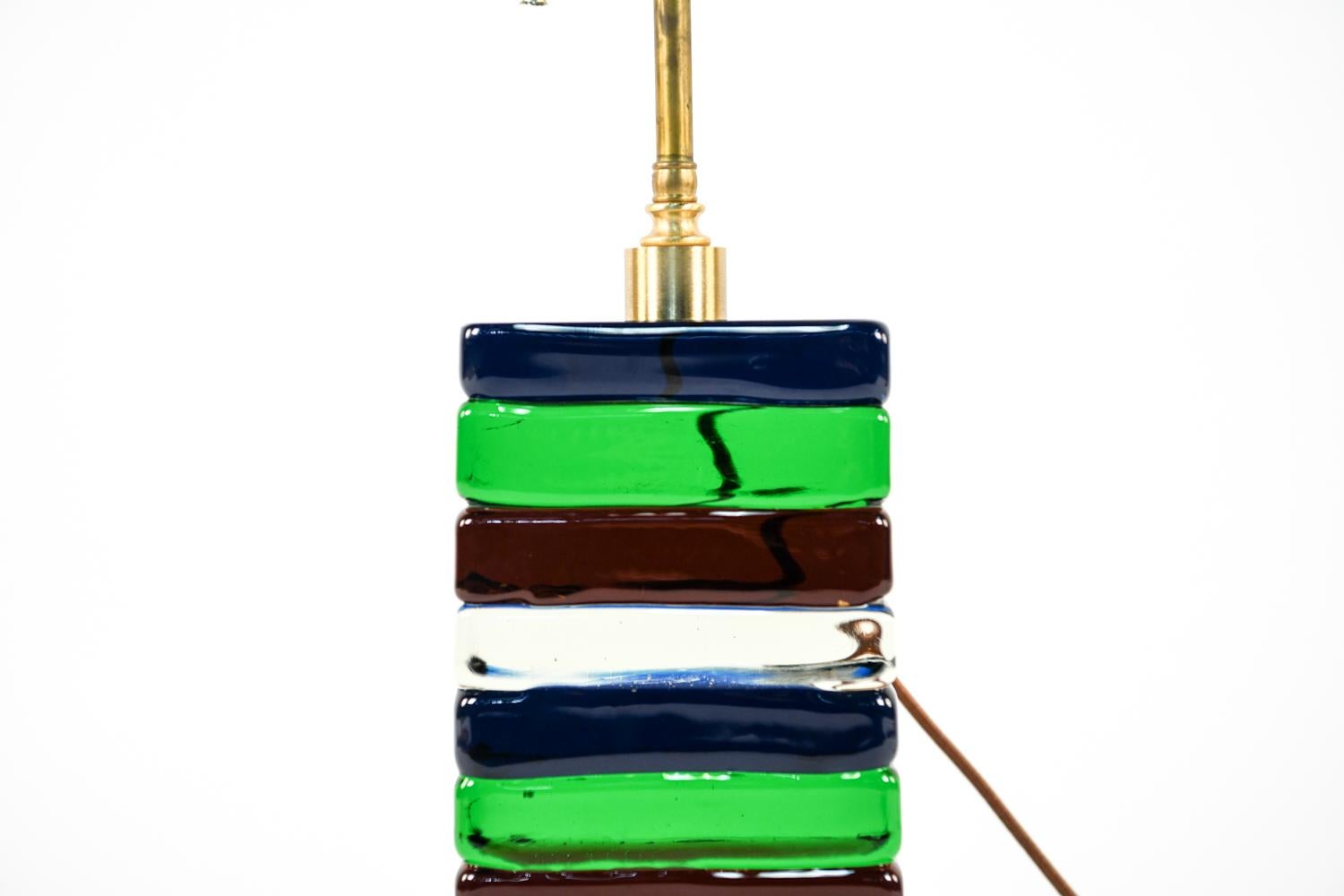 This stunning Italian contemporary table lamp by Cenedese features colorful, stacked Murano glass and brass hardware giving it an exquisite appearance when light shines through.