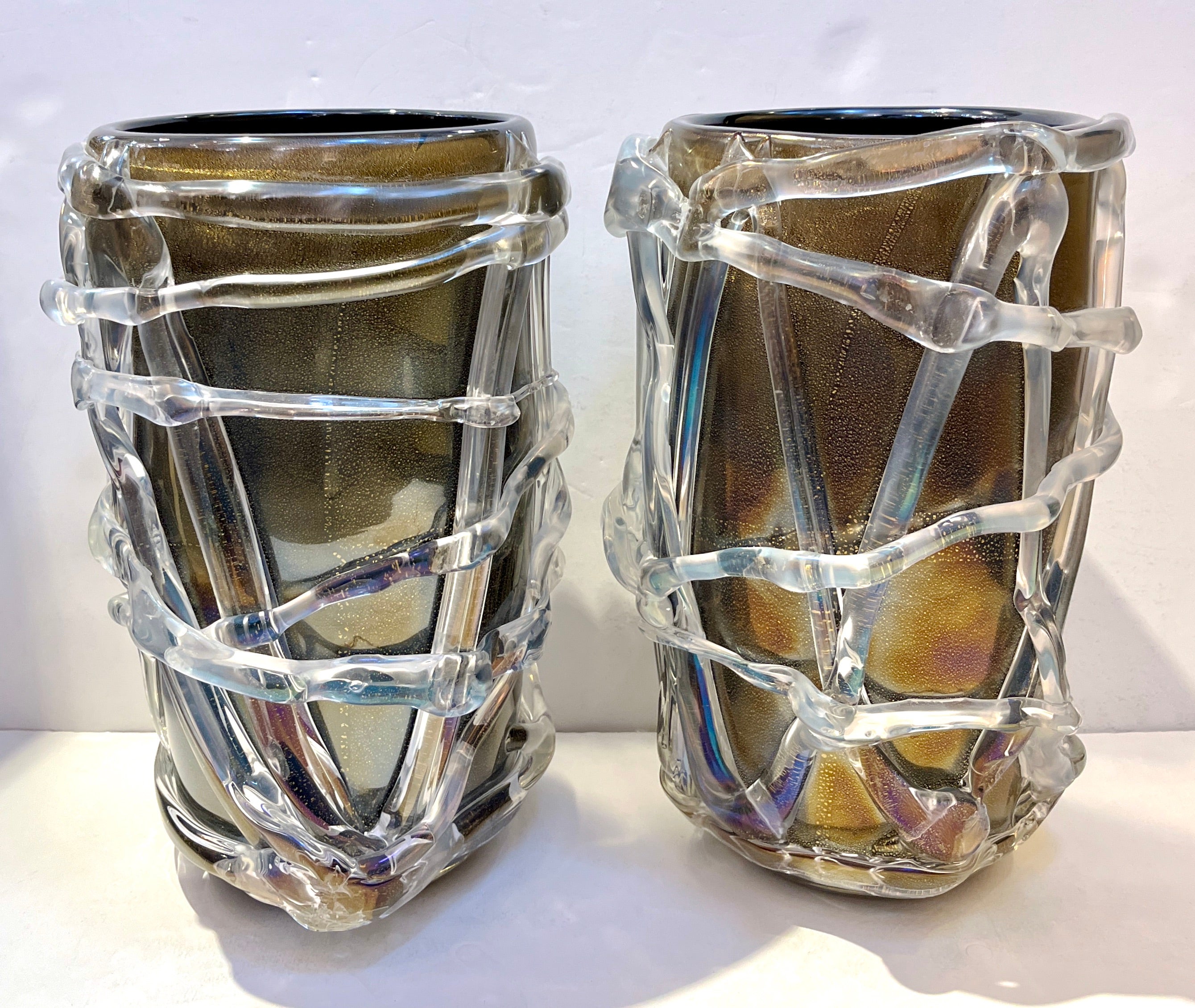 A superb unique pair of glowing iridescent black and gold murano glass vases of very modern execution, the blown glass body with an attractive and delicate craftmanship in black color, worked with a technique similar to the 