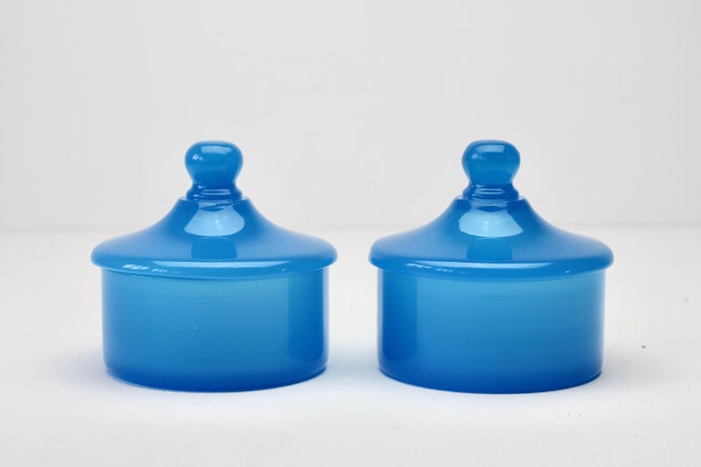 Cenedese vintage midcentury pair of new old stock Murano solid light blue colored / coloured glass round Apothecary jars or storage containers with lids made circa 1970 with original paper labels attached. Wonderful Italian glass and perfect for