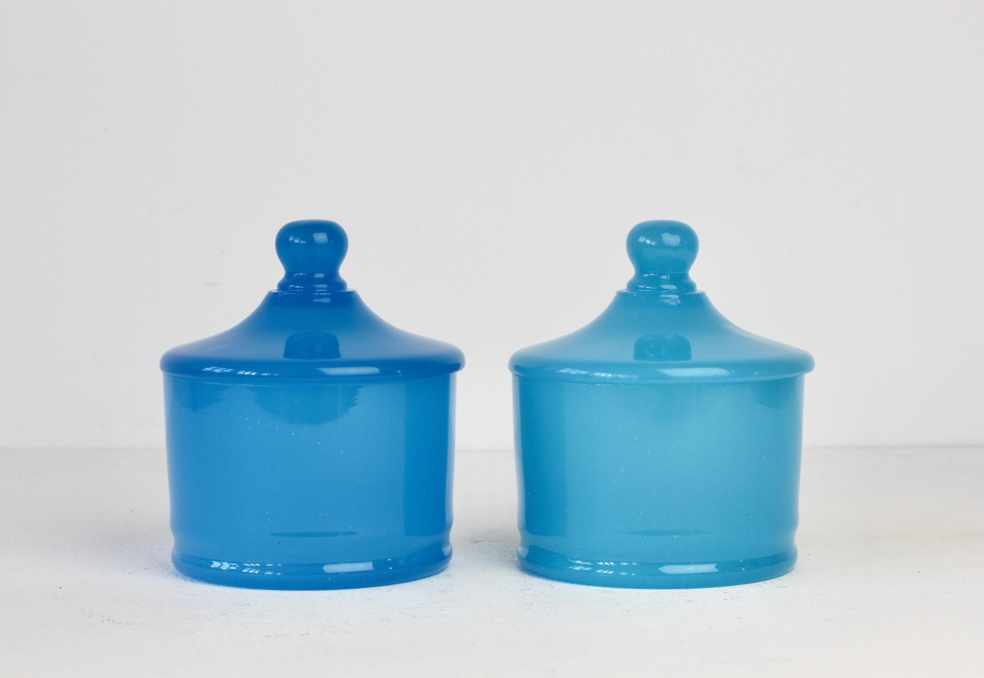 Cenedese vintage midcentury pair of new old stock Murano solid light blue colored / coloured glass round Apothecary jars or storage containers with lids made circa 1970 with original paper label attached to one of the vessels. Wonderful Italian