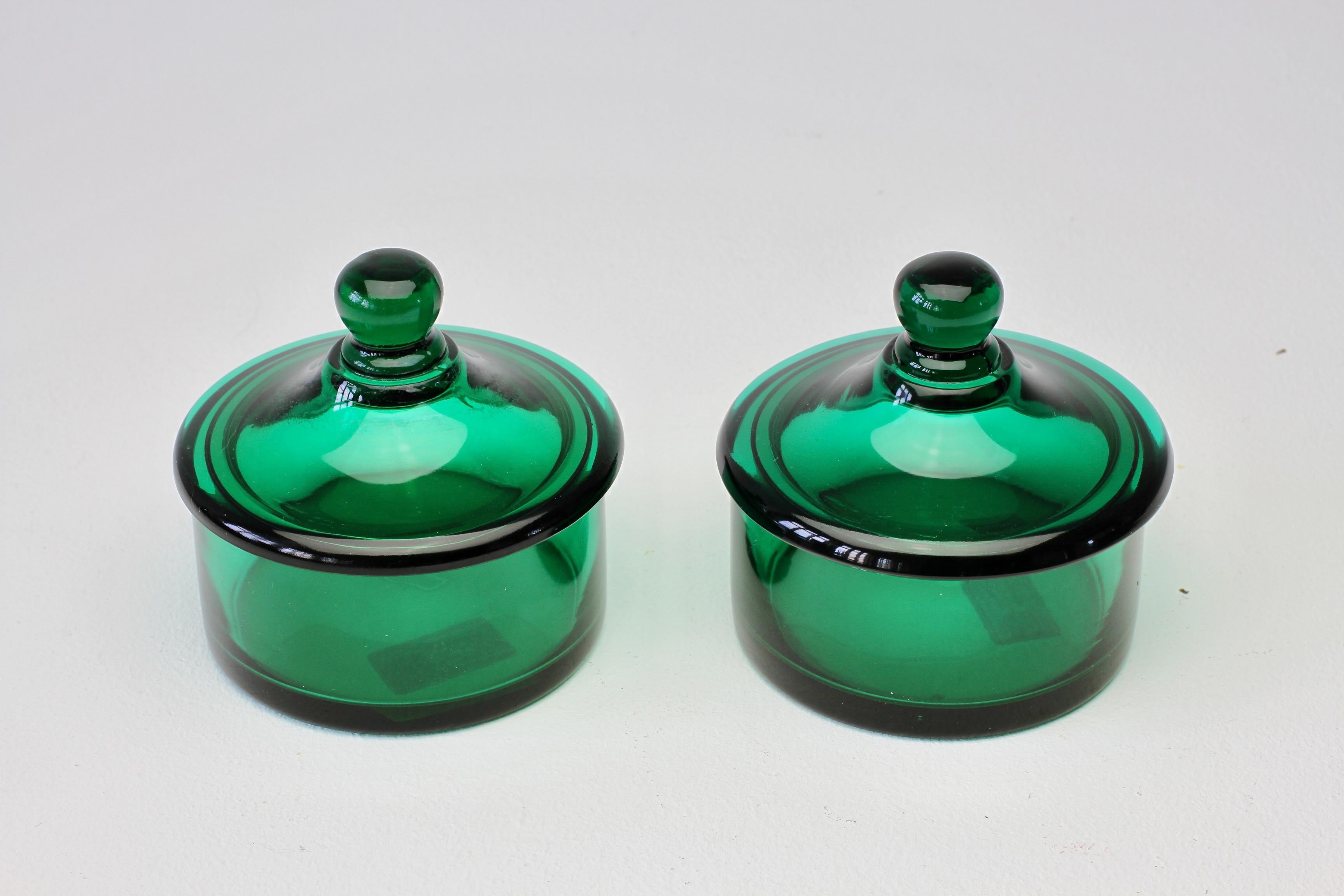 Paire de pots d'apothicaire ou de récipients de stockage ronds en verre Murano transparent/translucide de couleur vert émeraude avec couvercles, fabriqués vers 1970, avec étiquettes originales en papier. Merveilleux verre italien et parfait pour le