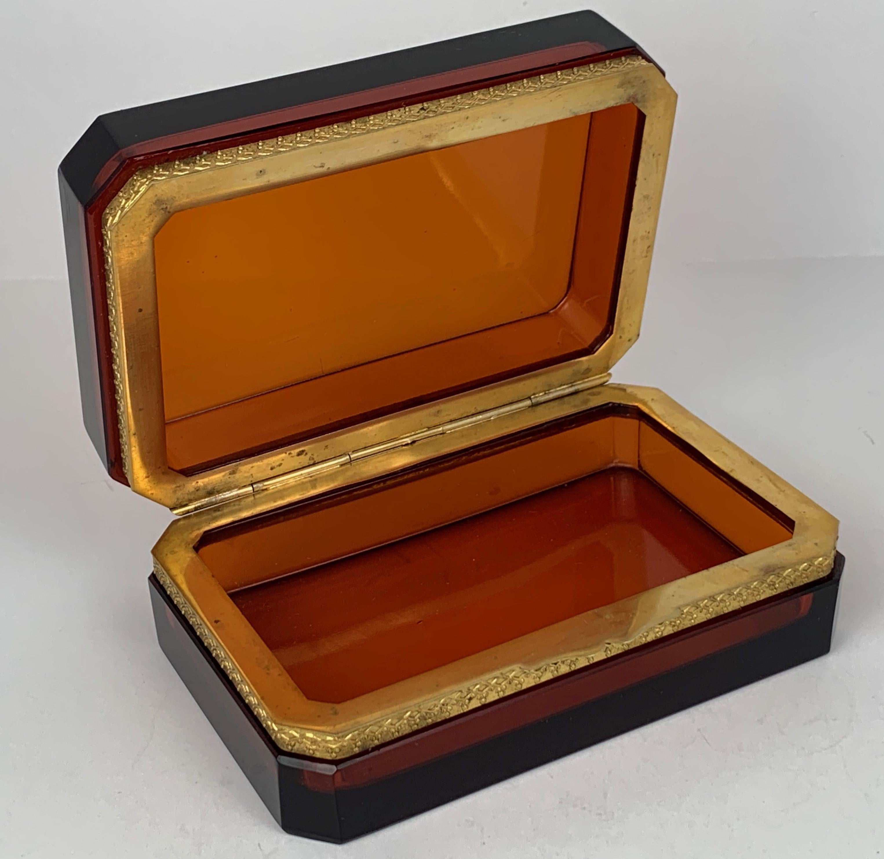 Dark amber hinged glass box with gilt frame by Cenedese, Murano, Italy. Rich amber color accented with high gold tones and heavy beveled glass. Suited to hold most anything or just looking great on a table catching light in any room.