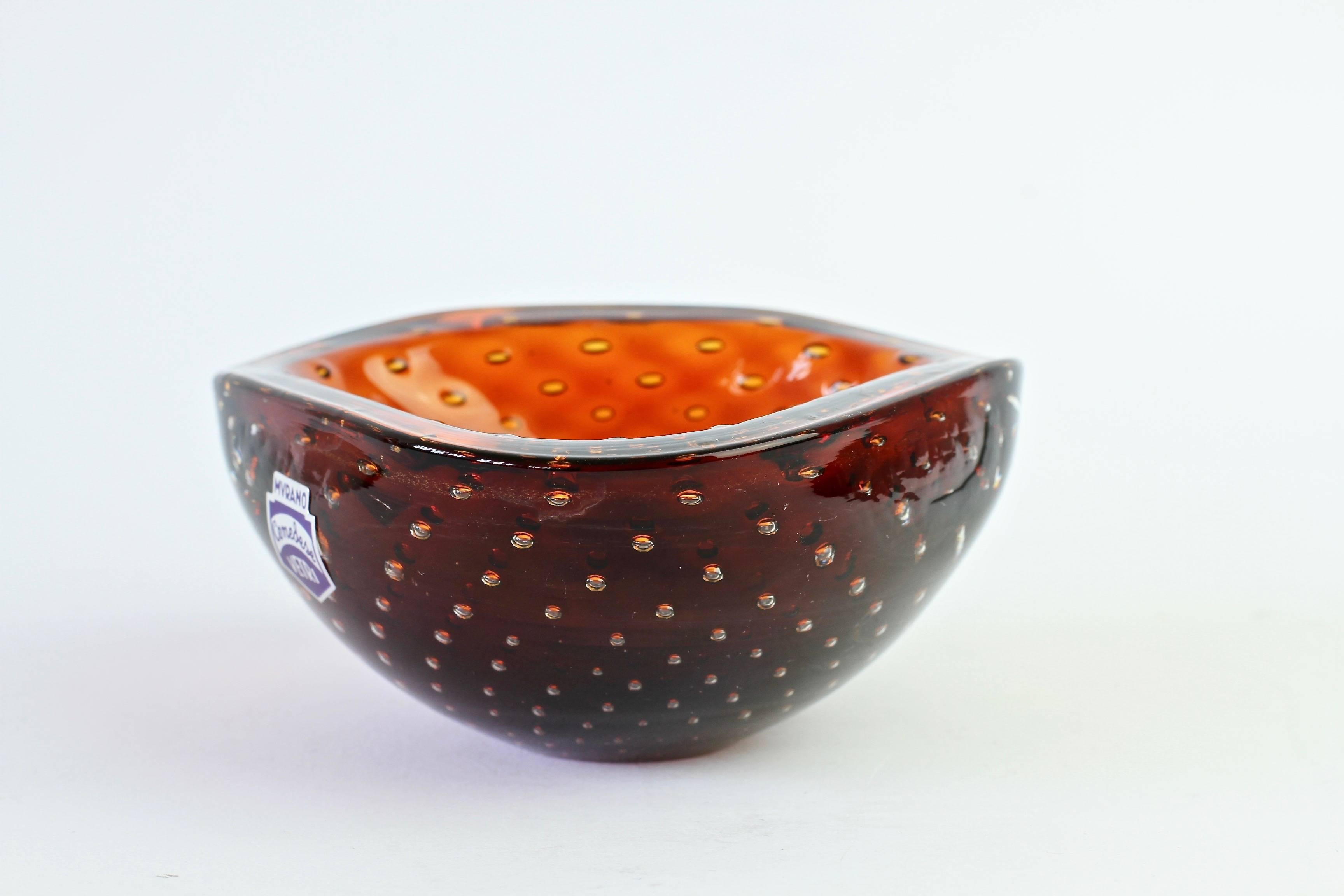 Small petite little Italian bowl or ashtray in the style of Venini by Cenedese. Made from amber colored / coloured Murano glass bullicante or 