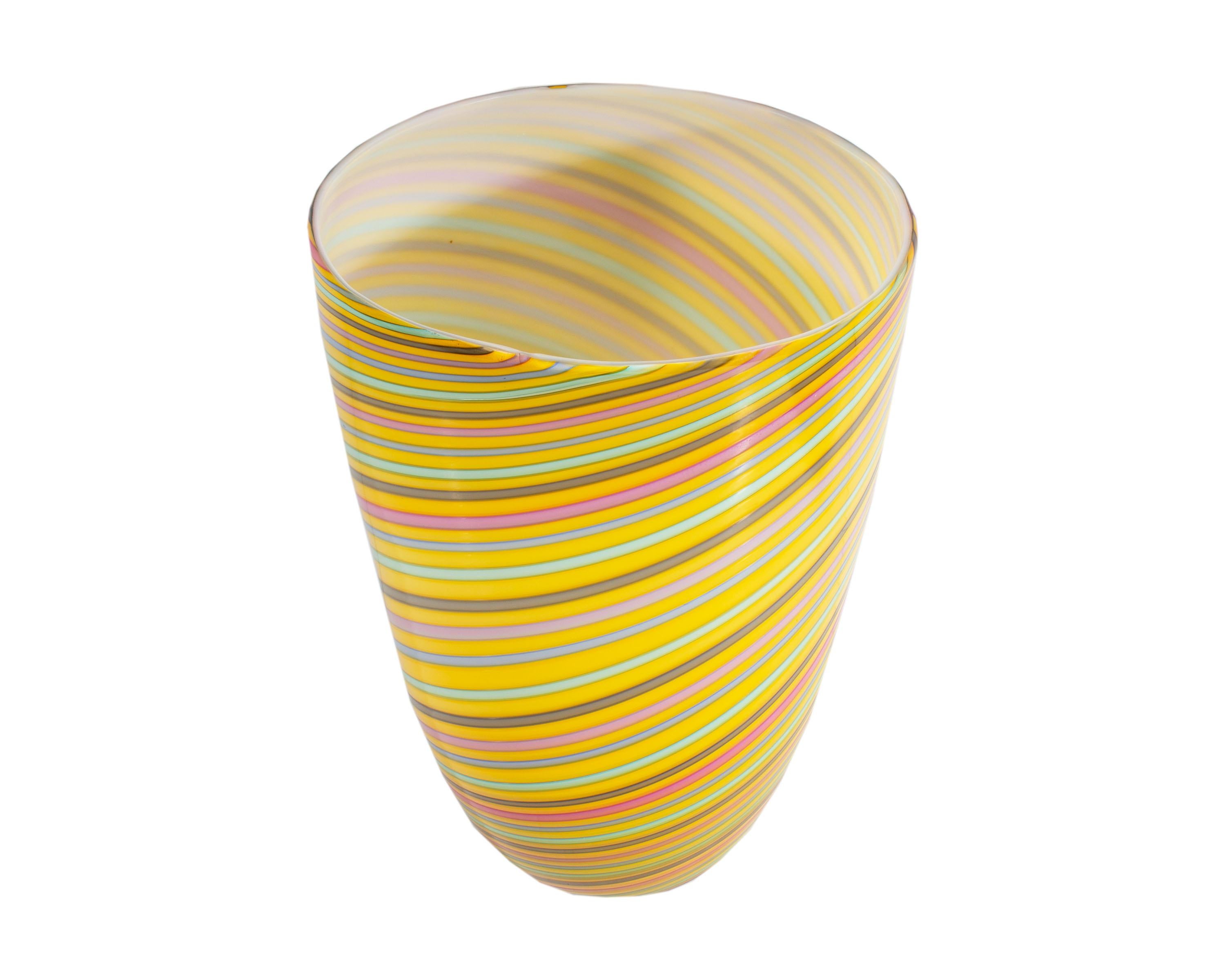 A vintage Murano art glass vase by Cenedese. Made in Italy, the oval tapered vase features alternating bands of color over yellow. Evenly patterned hues of blue, green, and pink form a spiral upon the yellow and white cased vase. The vase is signed