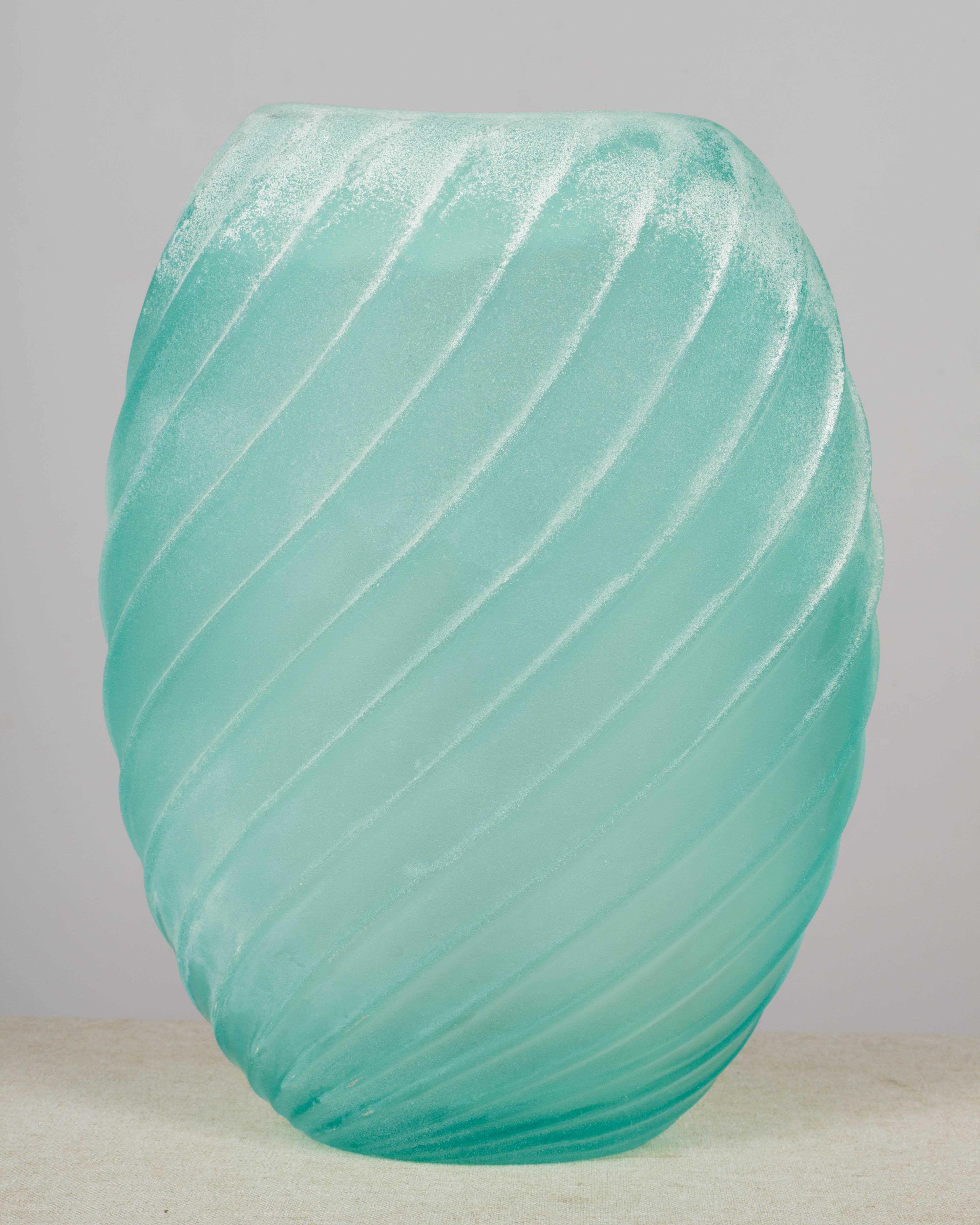 A large murano scavo glass vase by Gino Cenedese with oval form and swirl indentation. Beautiful aqua, or seafoam green color and rough texture. Scavo is a technique used to create an effect similar to weathering, imitating glass from an