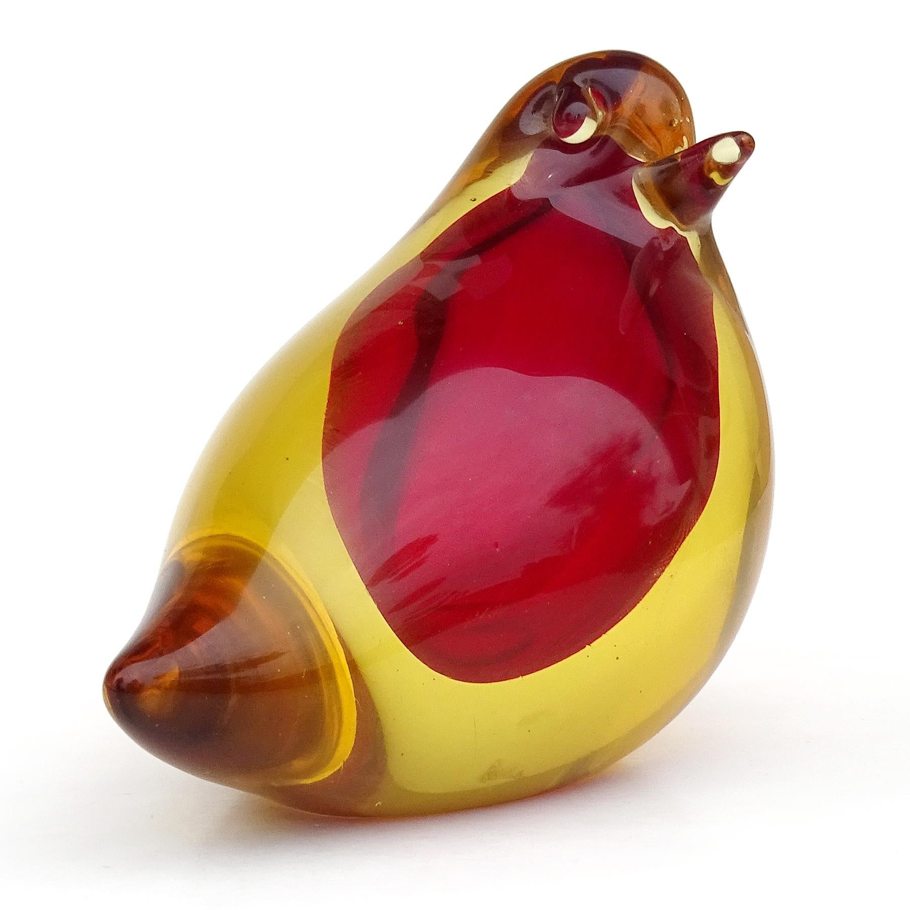 Beautiful and cute vintage Murano hand blown Sommerso yellow orange over red core Italian art glass baby bird figurine / paperweight. Attributed to the Cenedese company, and to designer Antonio Da Ros. The bird is made of solid glass. Created in a