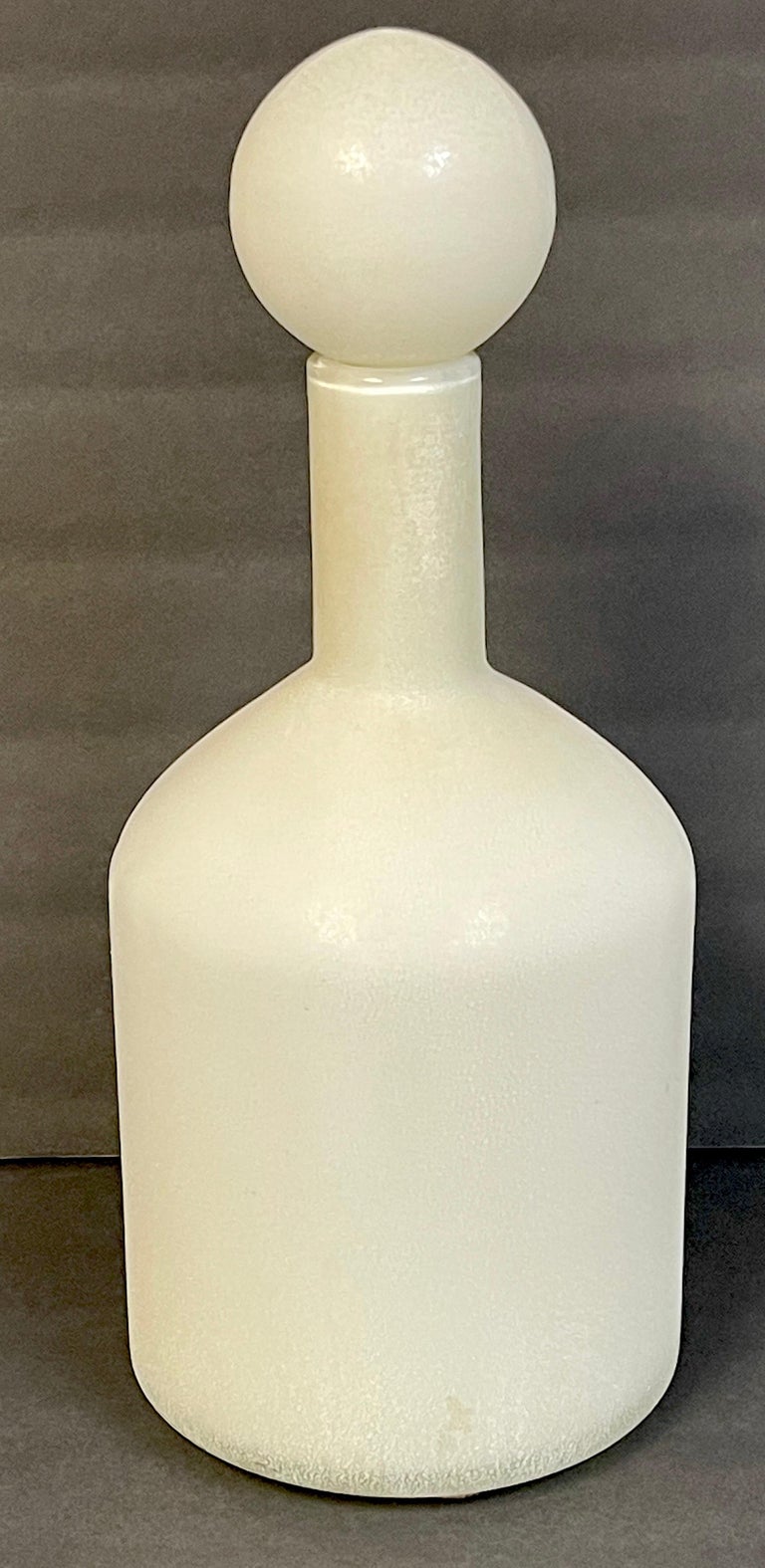 Cenedese murano white-scavo decanter bottle with ball stopper.
Italy, circa 1980s.

We are pleased to offer this large and sculptural (attributed) Cenedese Murano White-Scavo Decanter. Hand blown using the 'Scavo' technique, in this example its a