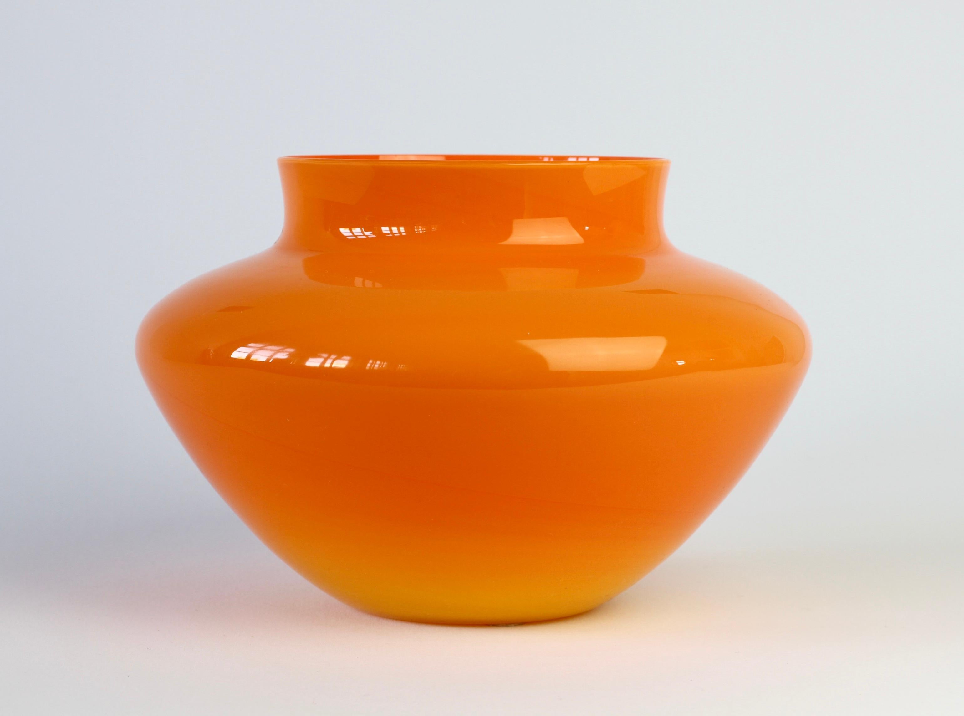 Cenedese bright orange Murano glass vase, bowl or vessel, made in Venice, Italy. Particularly striking is the form, it has the characteristics of hand thrown pottery with the unmistakable look and feel of glass.

A fun, funky and bright way to add