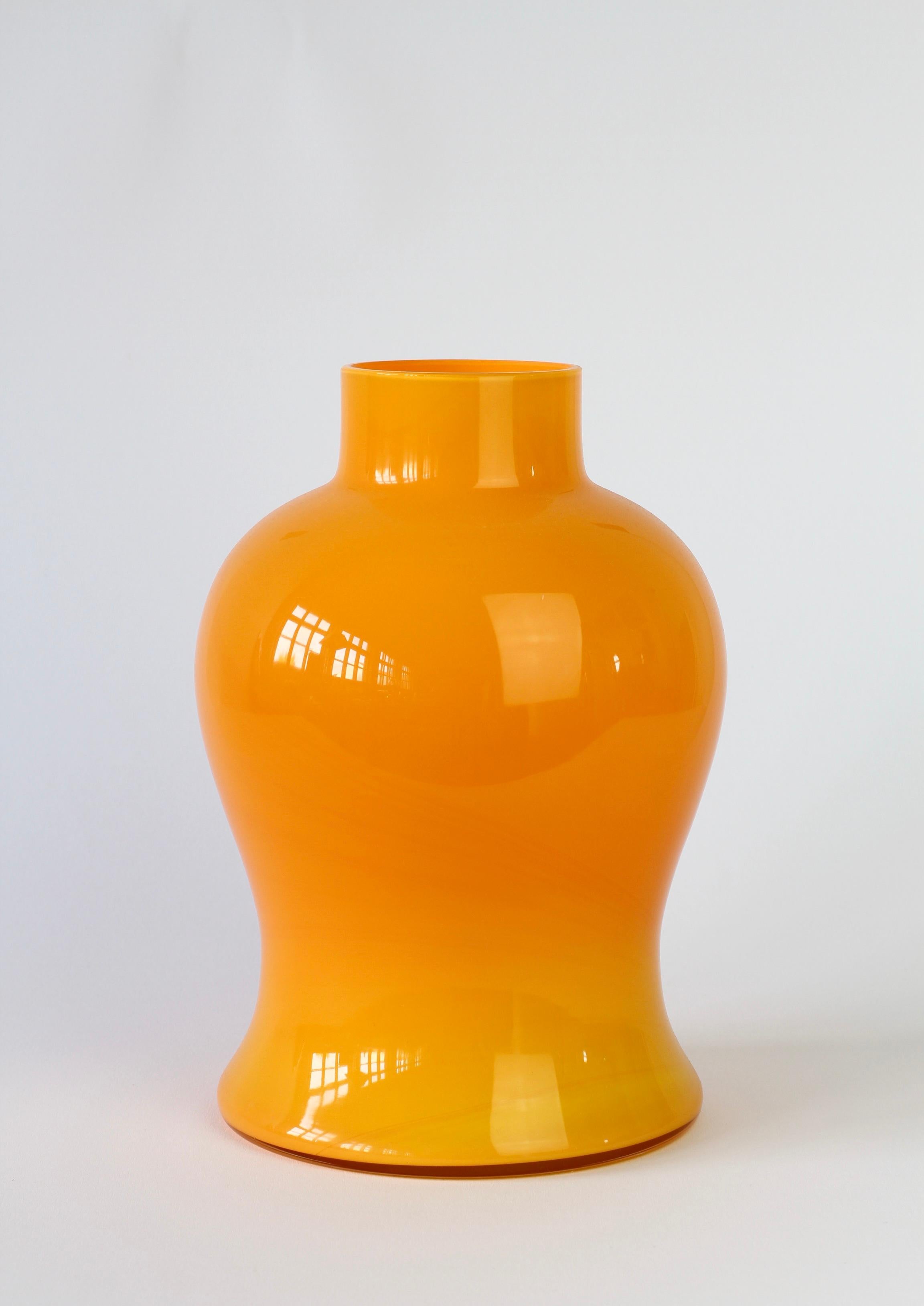 Cenedese bright orange Murano glass vase or vessel, made in Italy. Particularly striking is the form, as it has the characteristics of hand thrown pottery with the unmistakable look and feel of glass.

A fun, funky and bright way to add a touch of