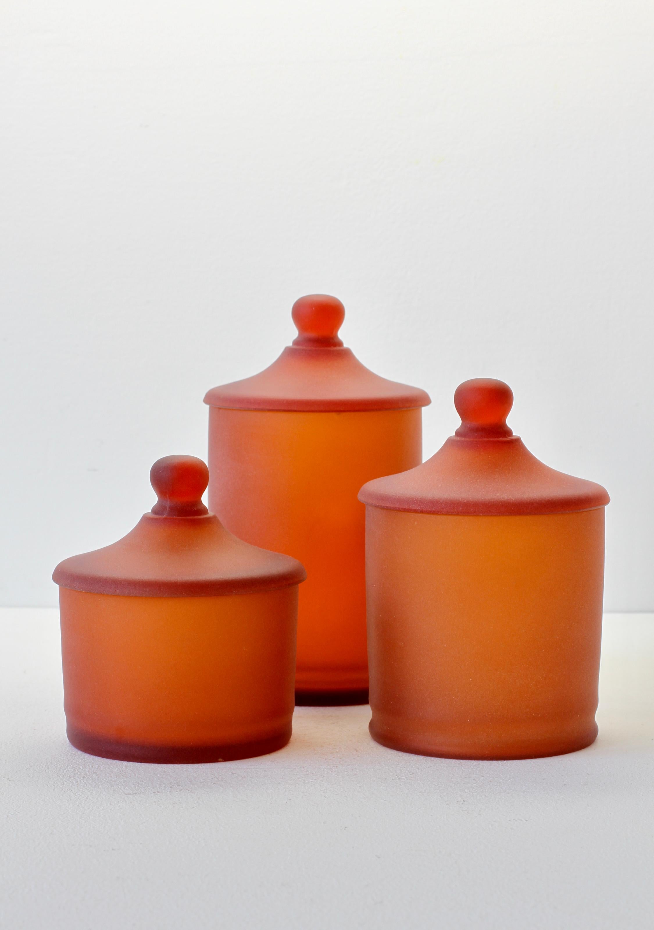 Rare set of three Venetian Murano amber colored / coloured glass Apothecary jars or urns with lids with an acid etched (corroso) finish. Wonderful vintage midcentury Italian glass and perfect for the storage sweets or snacks in the kitchen or for