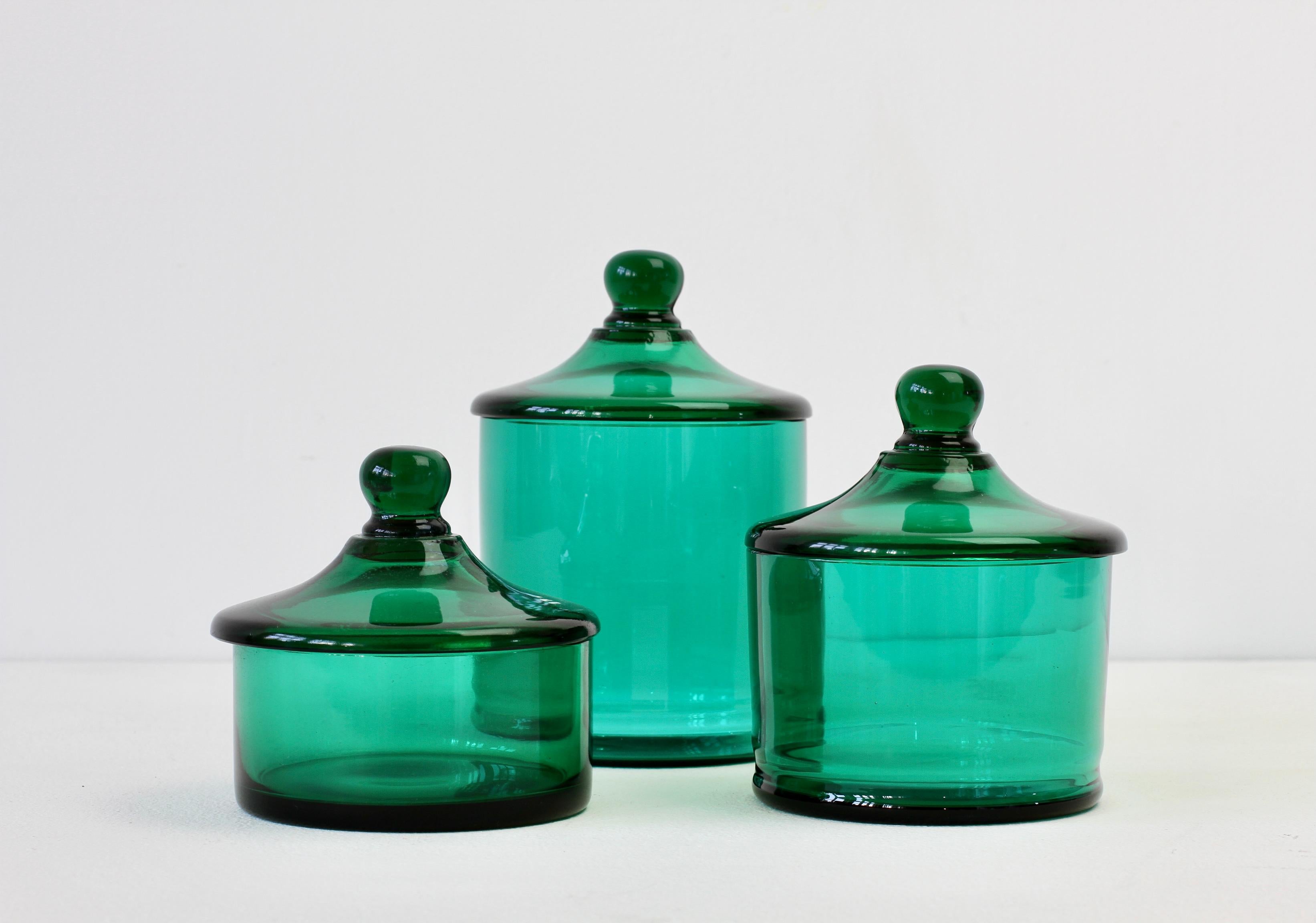 Rare set of three Venetian Murano green colored / colored glass Apothecary jars or urns with lids. Wonderful vintage Mid-Century Italian glass and perfect for the storage sweets or snacks in the kitchen or for cotton wool buds or cosmetics in a