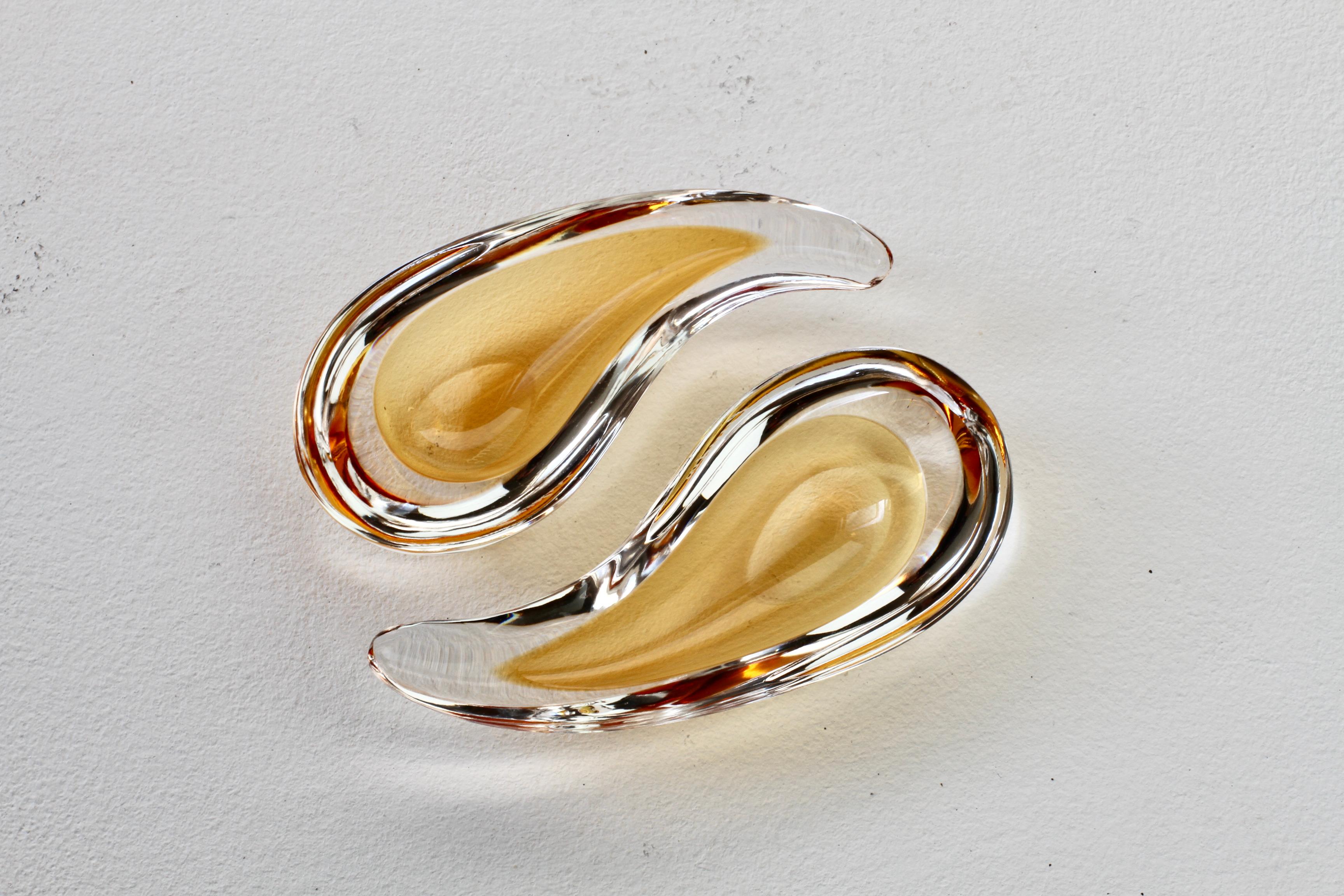 A beautiful pair of vintage midcentury Italian Murano glass ashtrays, bowls or dishes signed, Cenedese, circa 1960. Beautifully understated and elegantly simple translucent amber and clear Sommerso (submerged) glass in a soft, organic water droplet