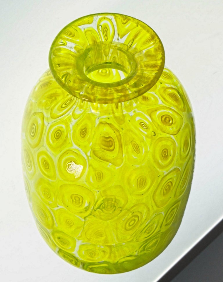 Very special vase. I have seen the uranium yellow used in cased glass sommerso or in drinking glass from Cenedese but never as Murrine.
These are simple circular murrinas alternating yellow and clear glass, creating a faded effect of