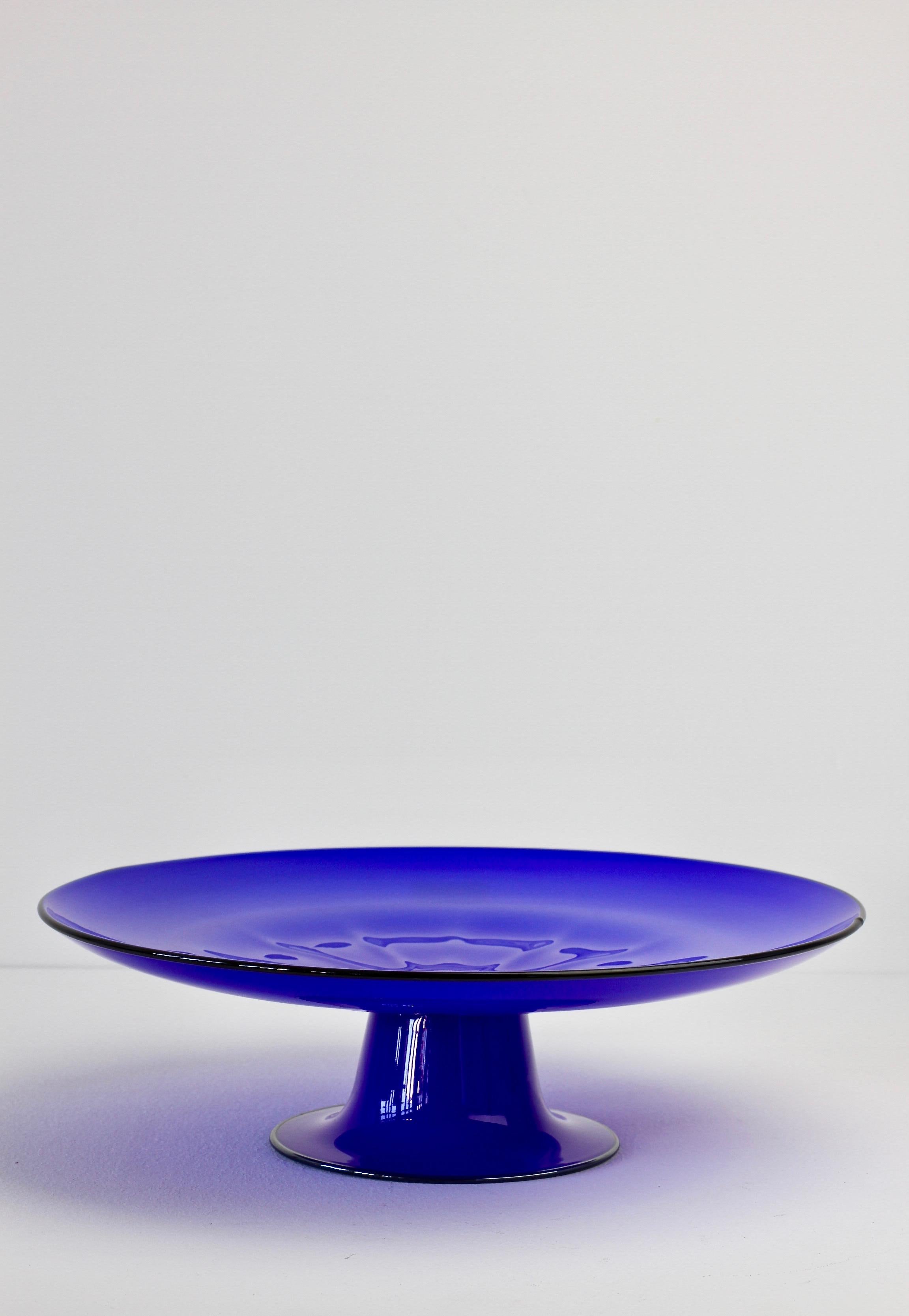 Glass cake stand or serving plate by Cenedese. Wonderful color/color of blue with black banding and simplistic yet elegant form. Fun to dine with vibrant vintage midcentury Murano glass serveware.
