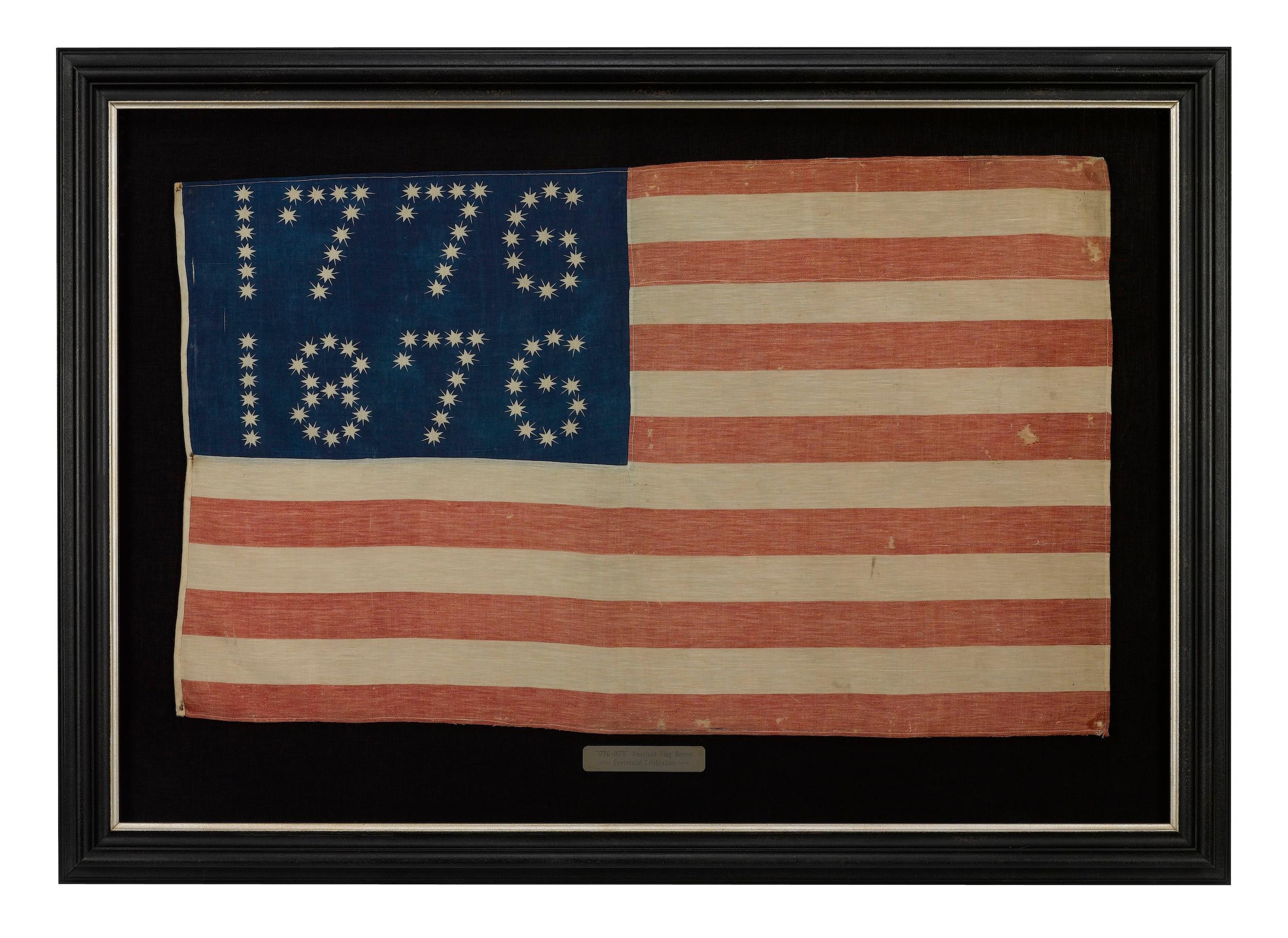 Presented is a rare Centennial patriotic flag banner, dating to 1876. The flag’s brilliant blue canton is spectacular, with 81 five-pointed, rayed stars, arranged to read “1776” and “1876.” The flag’s design is completed with thirteen alternating
