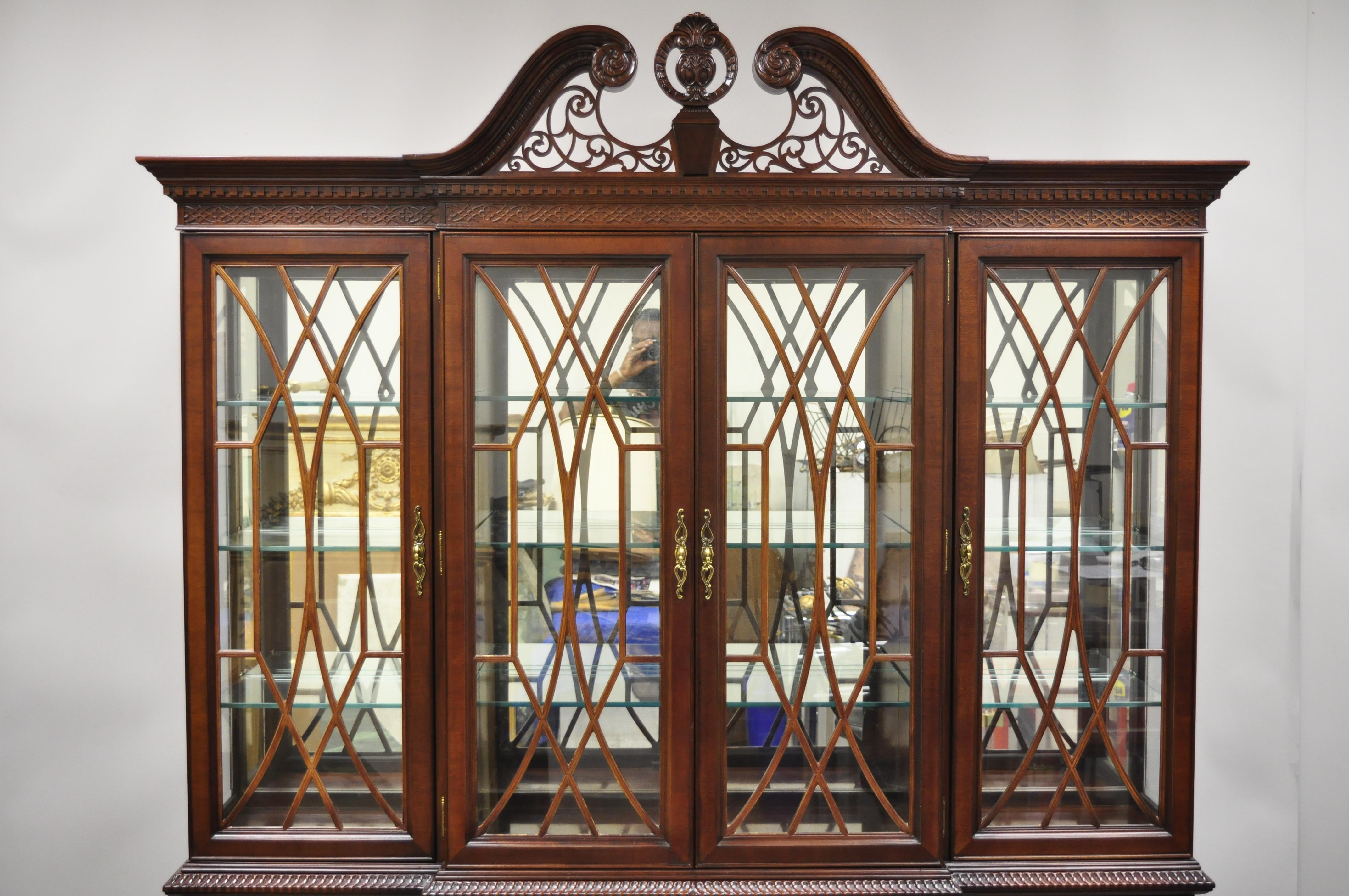 The Centennial collection Bernhardt mahogany Chippendale style breakfront china cabinet. Listing includes a solid wood construction, beautiful wood grain, nicely carved details, 2-part construction, lighted interior, 8 swing doors, original label, 3