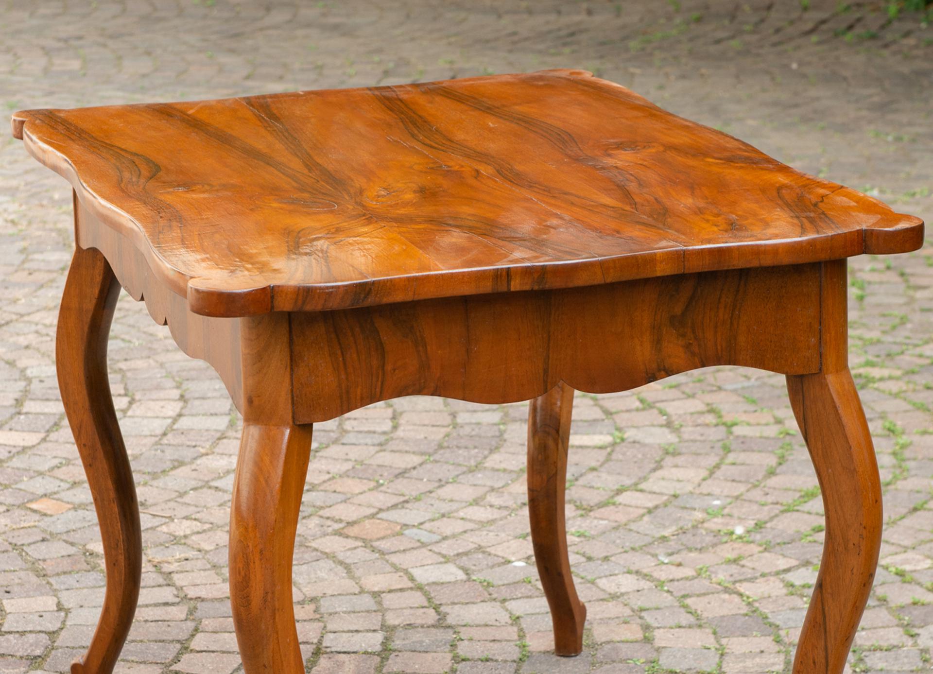 Elegant Biedermeier desk with drawer, perfect as center table.  Beautiful walnut wood, whose grains form a very interesting abstract design on the top.  The drawer in the edge around the top is almost invisible.
That's a good price for closing
