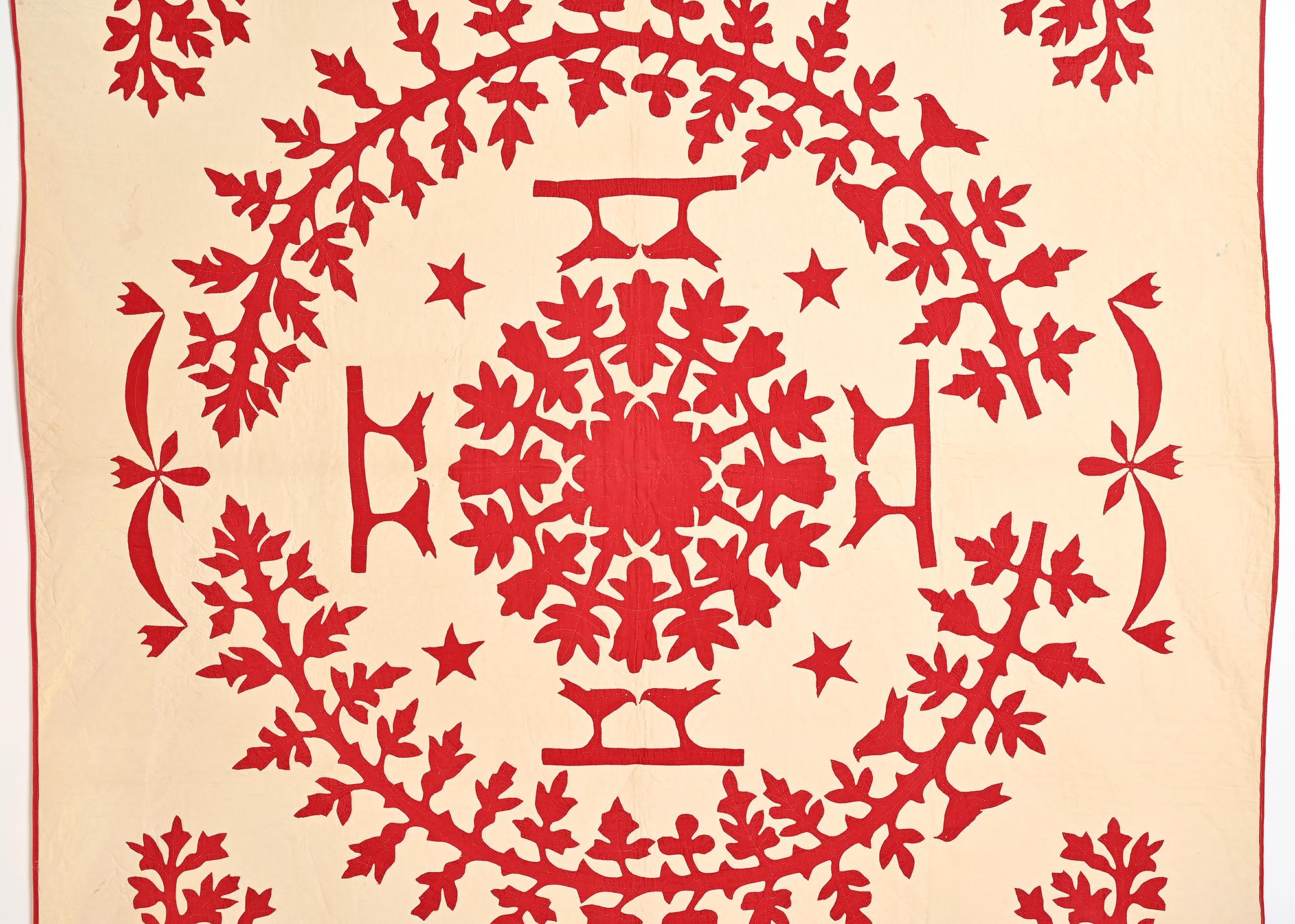 At first glance, some would think this is a Hawaiian quilt - not so. It is similar to Hawaiian in that it has the solid color central applique design but there the similarity ends. This quilt has pairs of lovebirds; stars and swags, not seen on