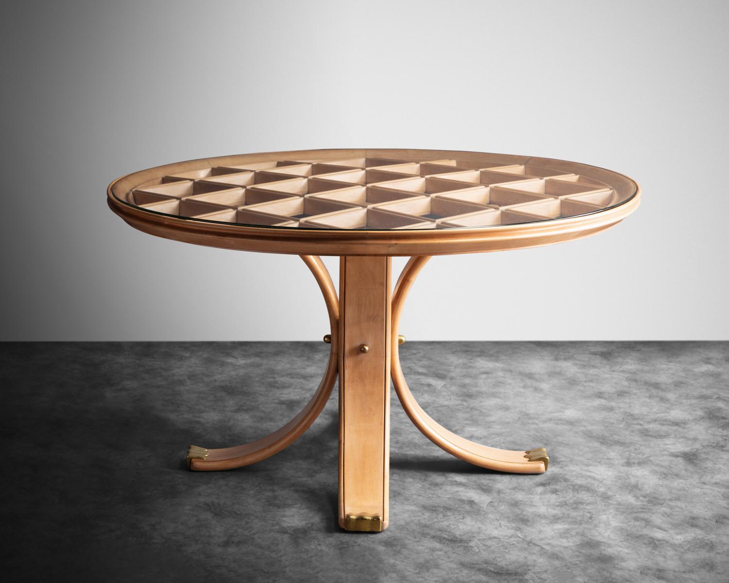 Pearwood table with the top done in lattice work, the four out-splayed legs ending in cast bronze sabots. Original glass top. The piece has been restored to its original condition through us (joints reinforced, wood and bronze cleaned, sealed). This