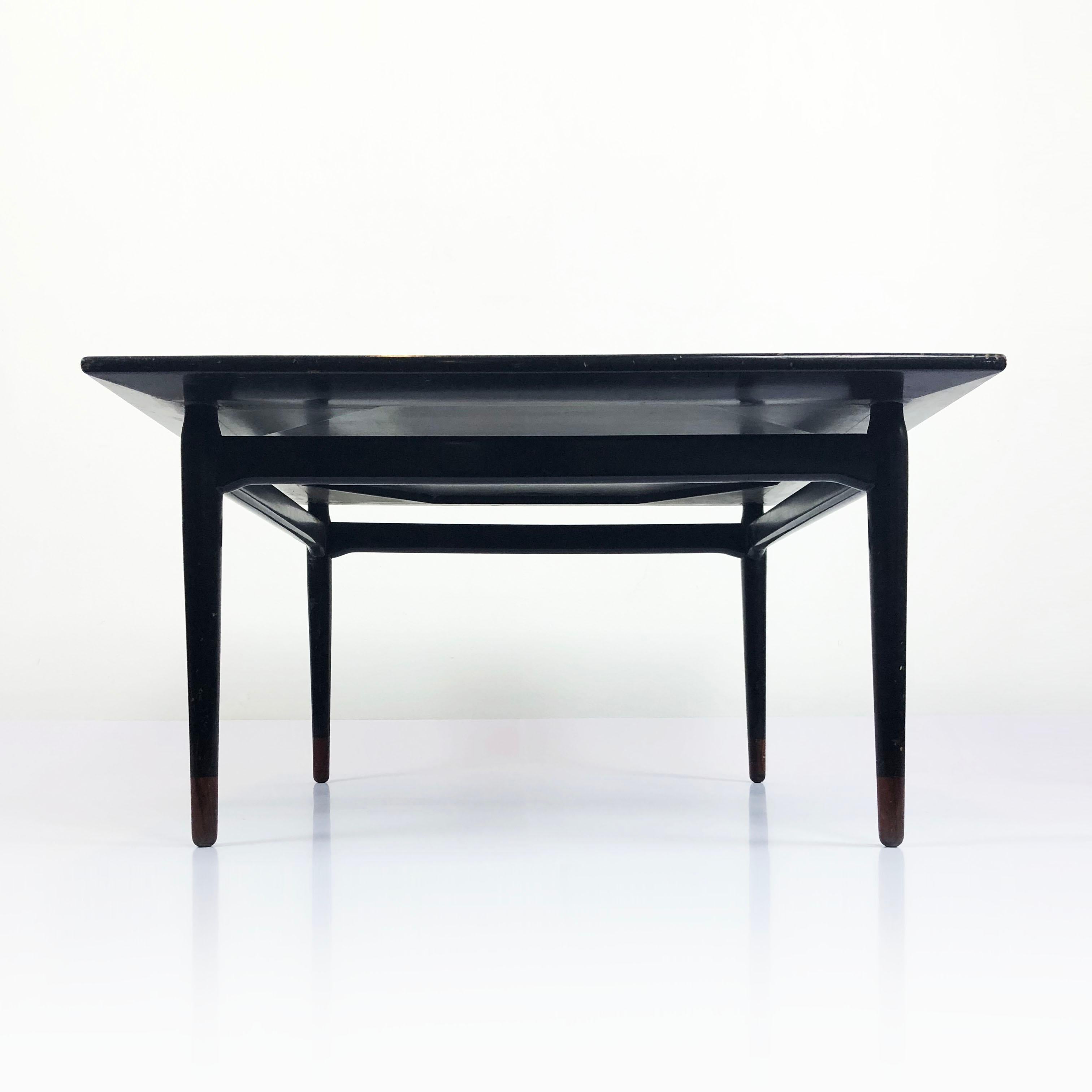 We offer this amazing table designed by Frank Kyle one of the most important designers of the midcentury Mexican Modernist, circa 1960. The table are made in mahogany wood with original lacquered black paint and with the characteristic duotone of
