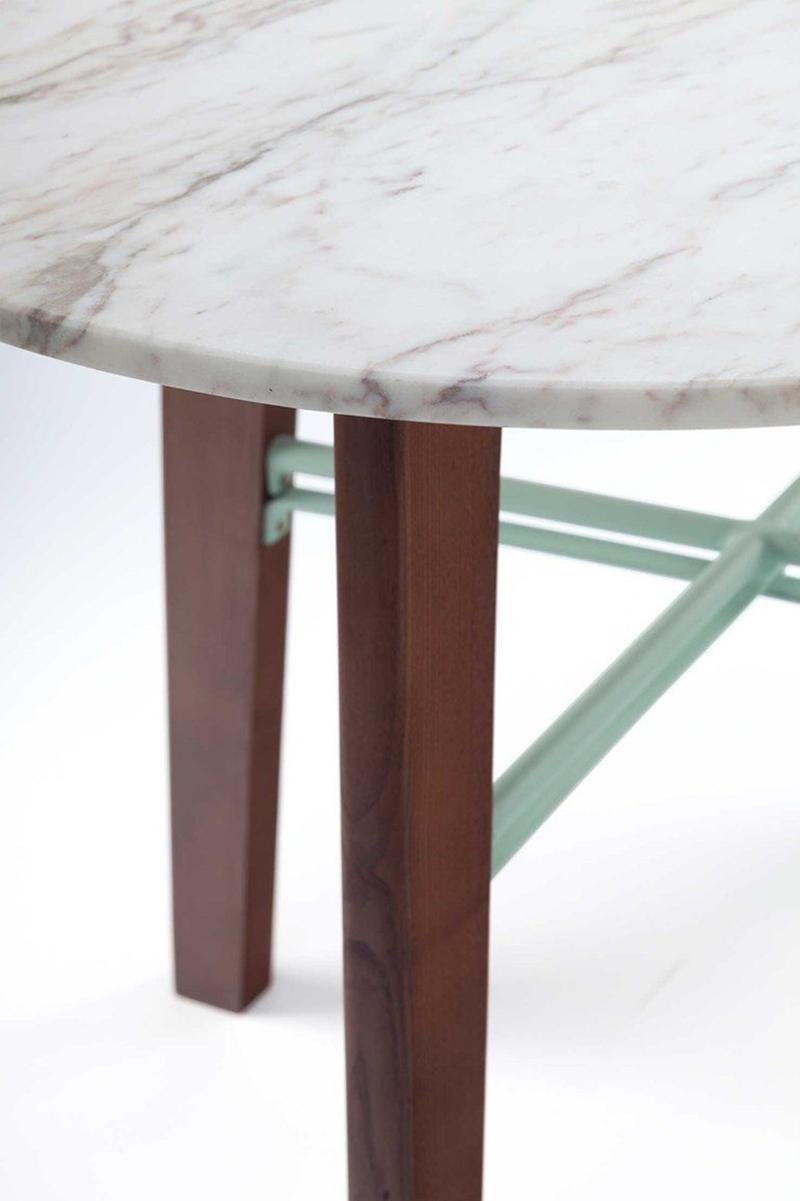 Flex center table has a solid beech wood base shaped elegantly, completed with a lacquered metal structure and receives a table top in Estremoz white marble. Made to Order. 

For sales with delivery address within European territories, VAT will be