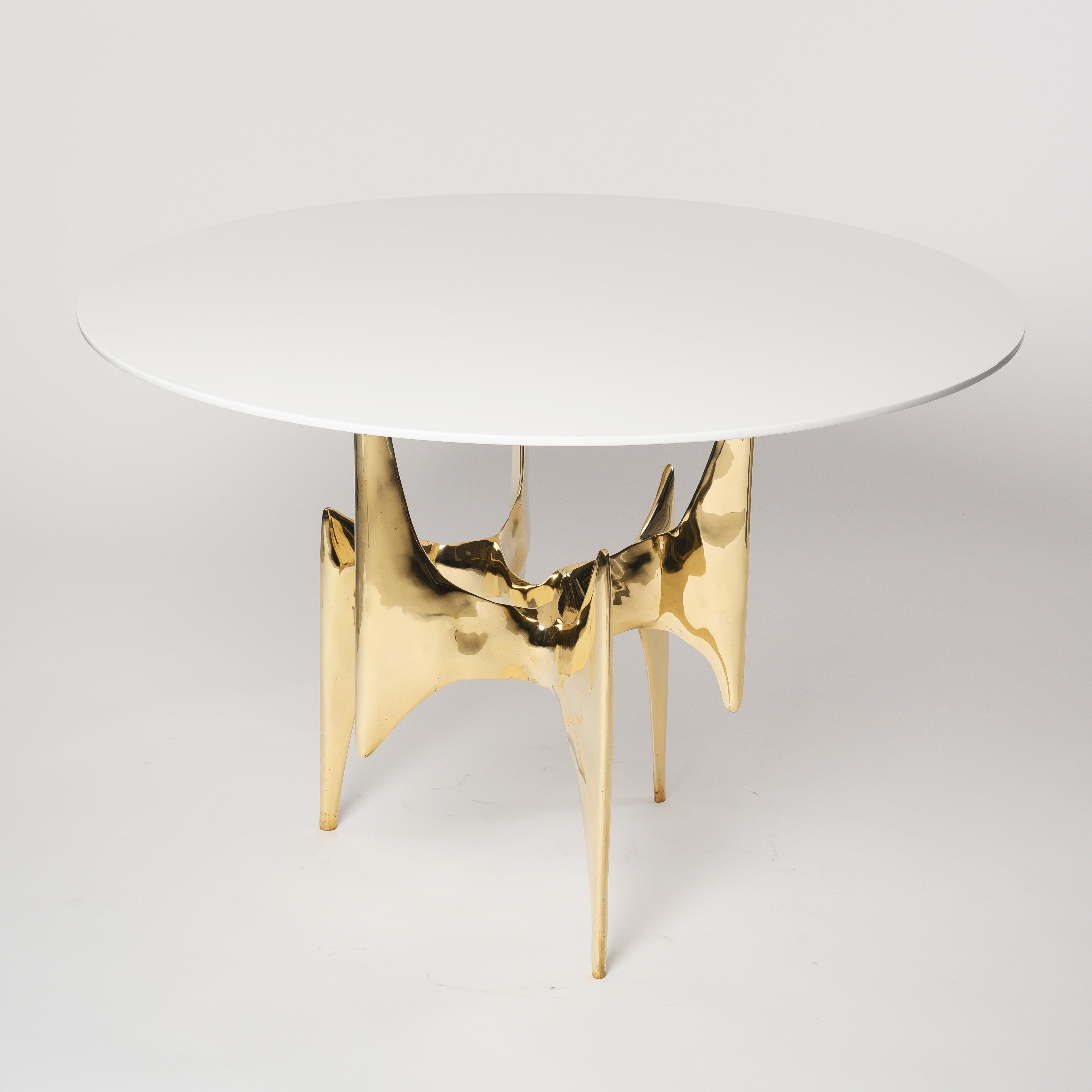 The Ella table is composed of a sculptural bronze base in a polished gold brass, finish. 

Ella is a modern interpretation on the great sculptors of the French Modernist period. 

The tabletop is shown in a white gloss lacquer and base is polished