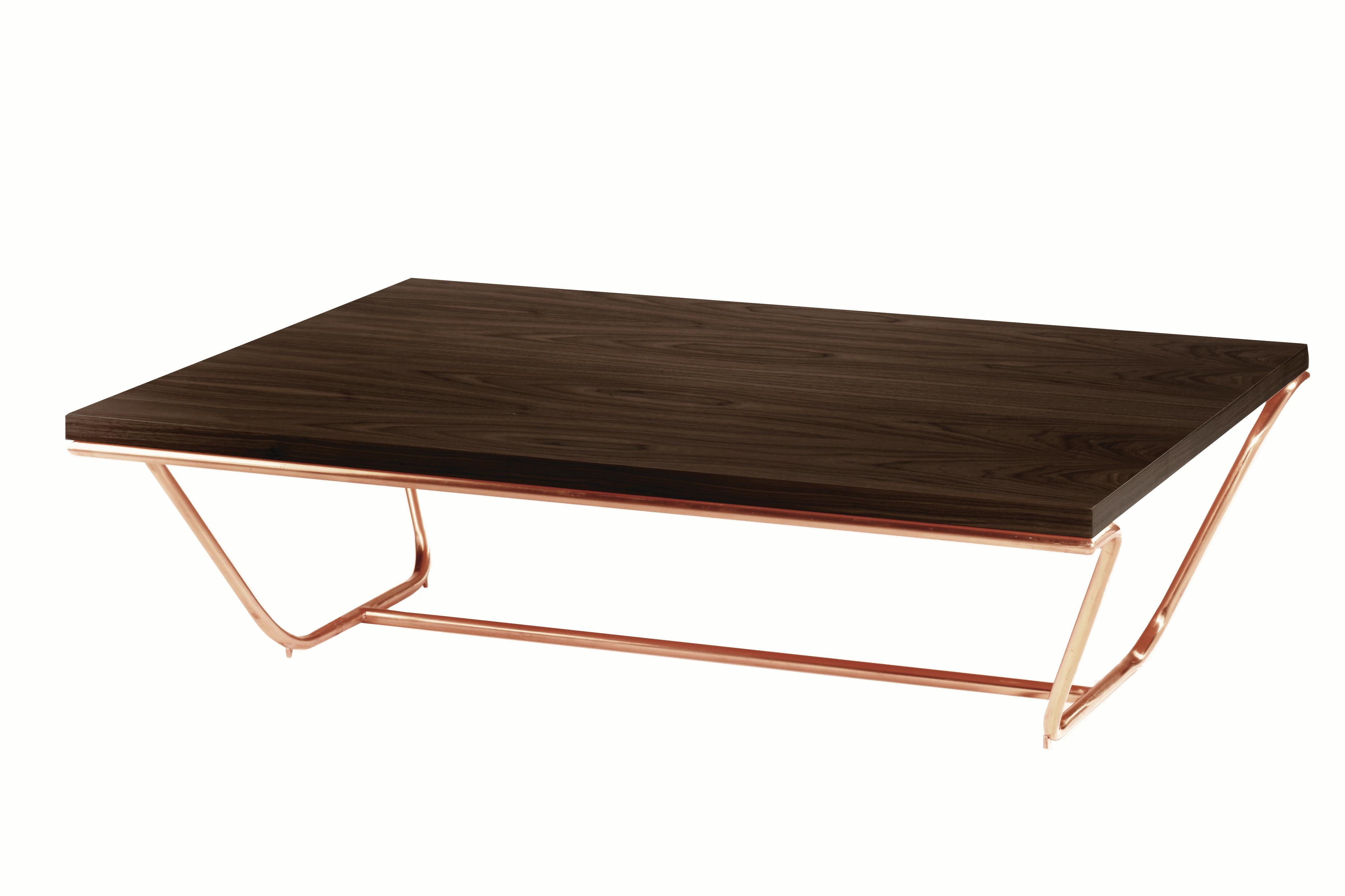 Brass or copper arms hold a luxurious wooden table top. These tables' elegance, with elements smoothly joined together, the base embracing the top, have almost a palpable musical presence to be discovered. Smooth reflection from the polished metal