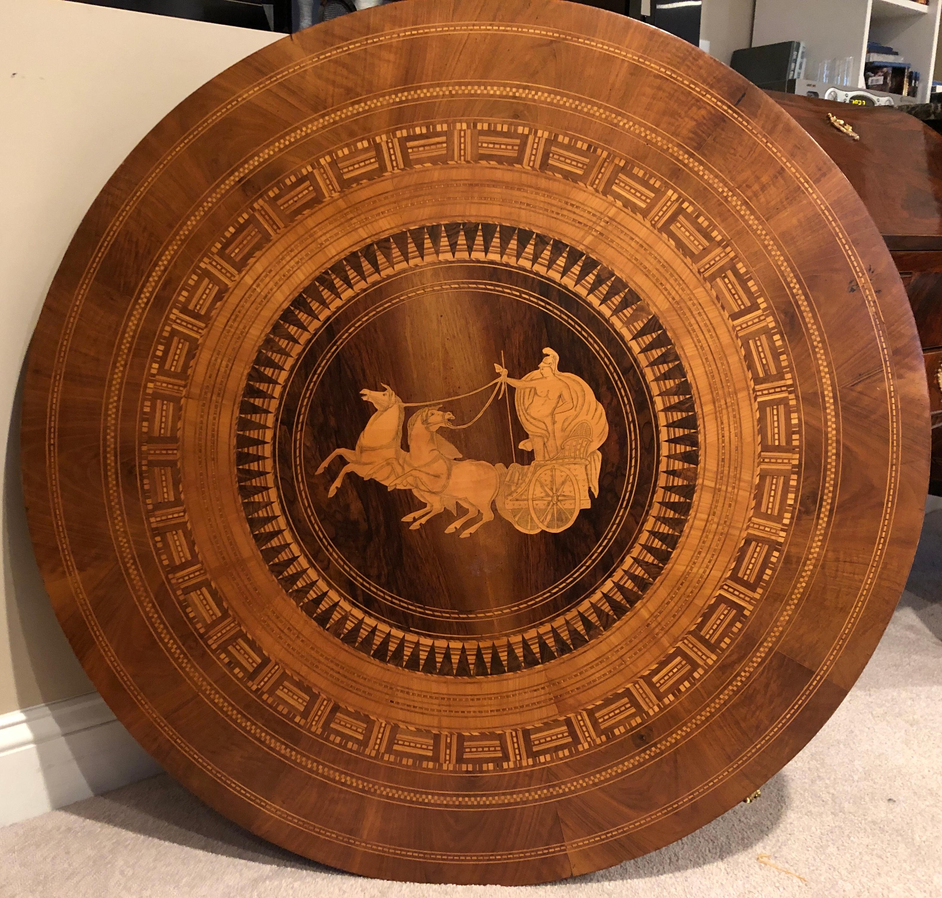 Beautiful center table, Italy 1860-1870, beautiful marquetry on top and base. In the central medaillon of the top the designer depicted a chariot. Exquisite craftsmanship. In good condition with original patina.