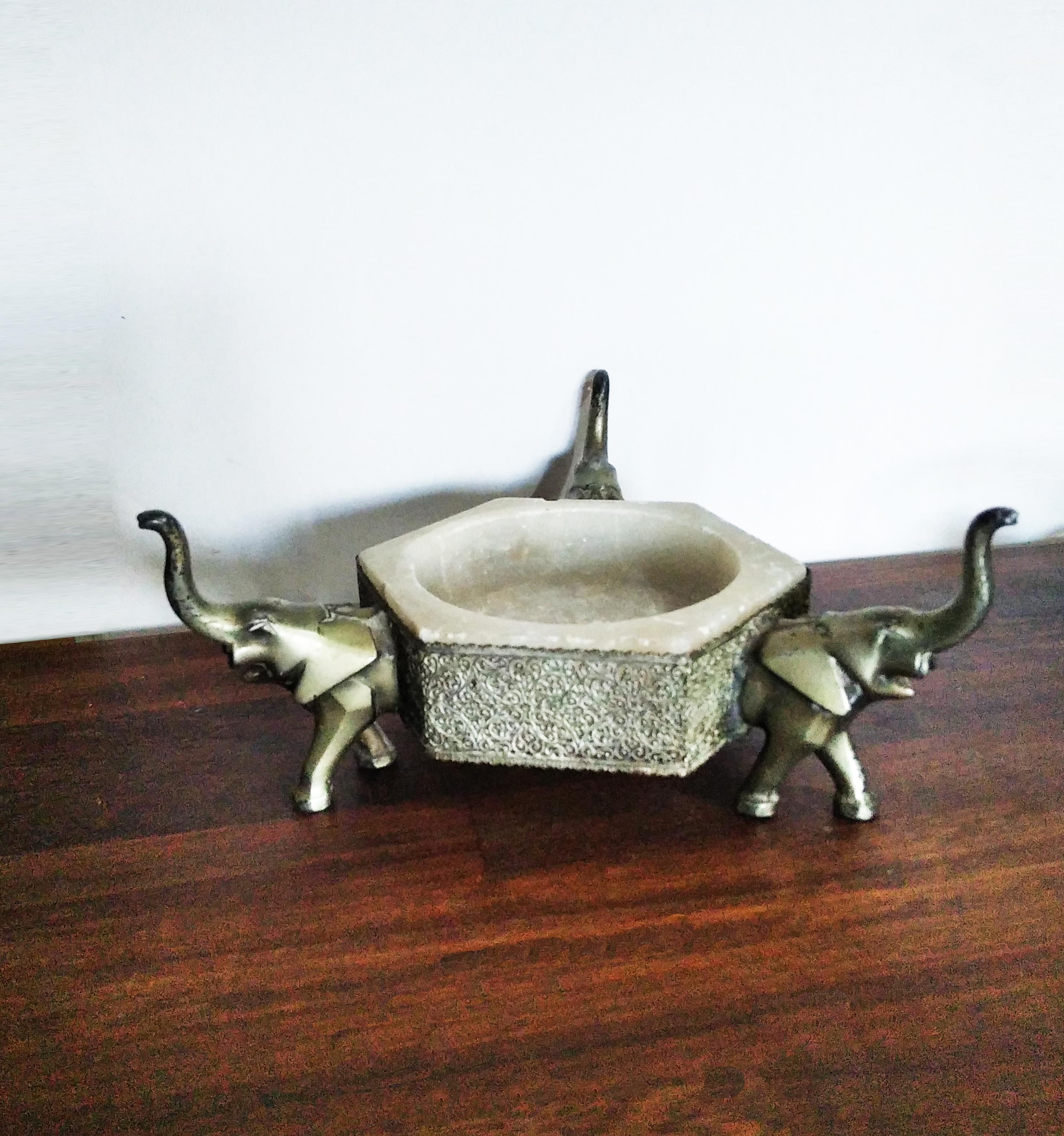 Alanbaster and metal or bronze centerpiece 

Alabaster bowl with elephant pedestal and metallic filigree.
     