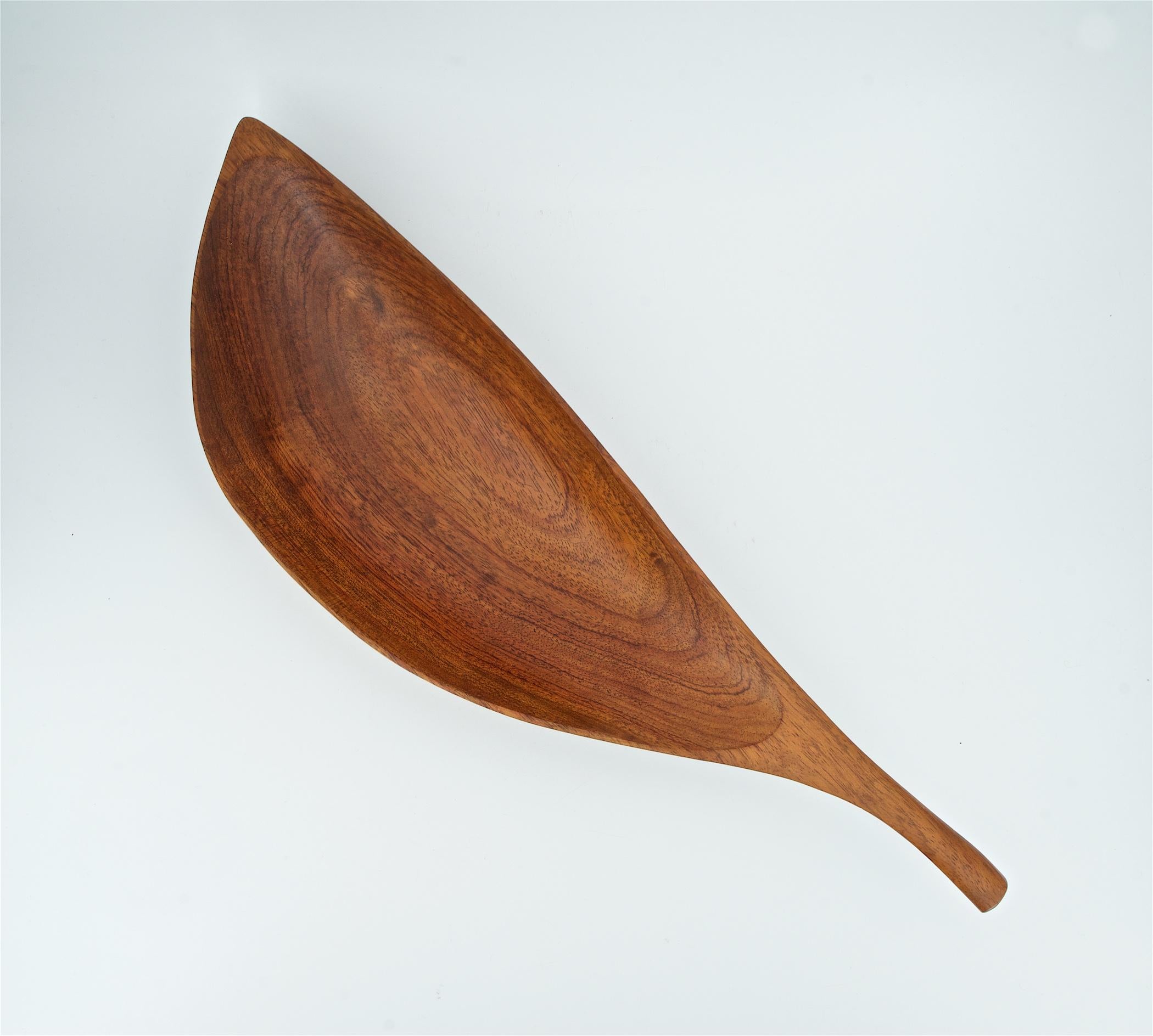 An iconic rare wood elongated bowl in African Teak (Bubinga) by Mid-Century master Emil Milan.