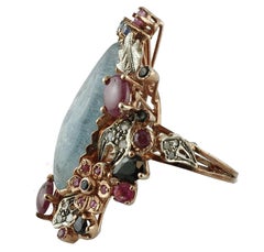 Central Aquamarine Diamonds, Rubies, Blue Sapphires 9 Karat Gold and Silver Ring