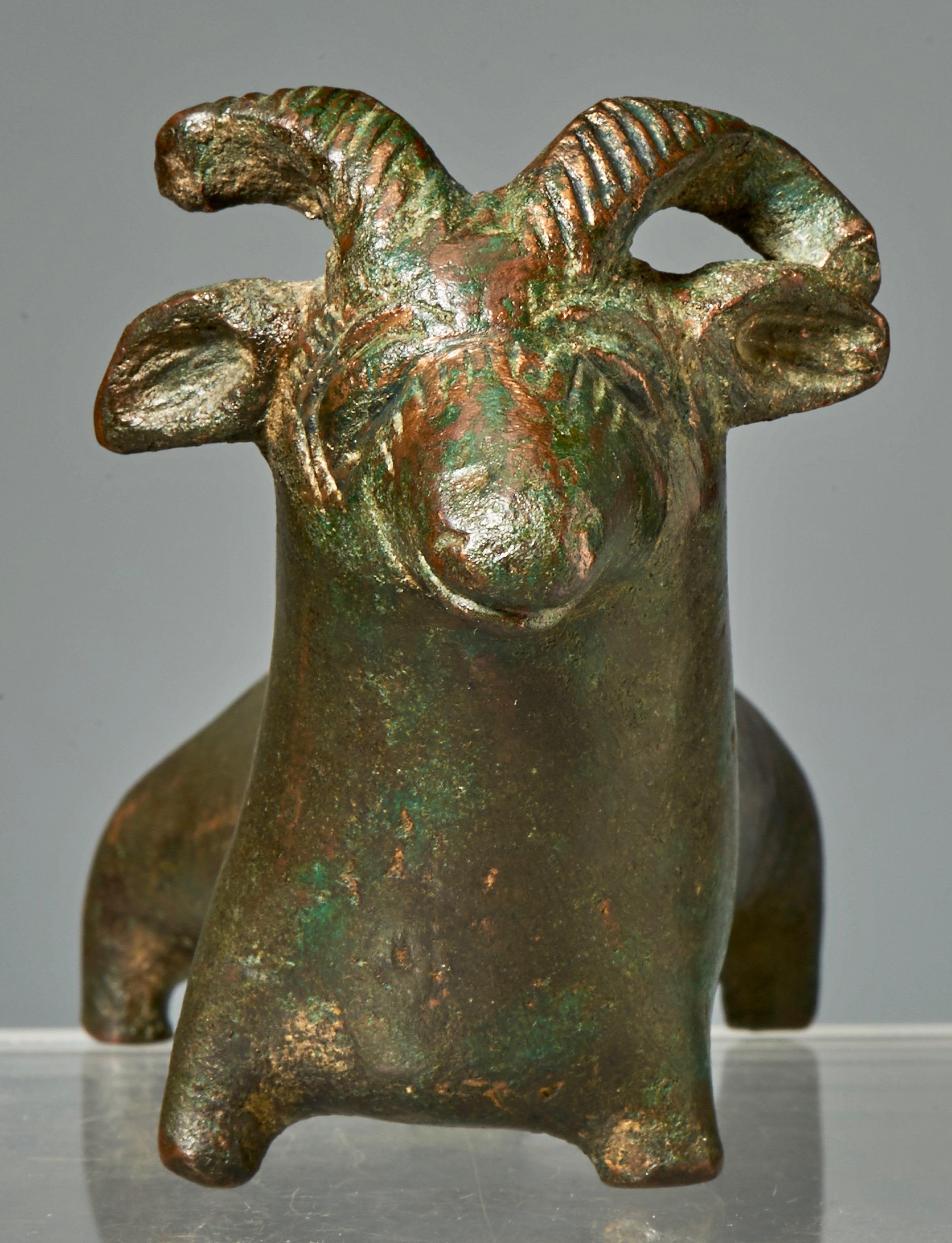 Central Asiatic, possibly Bactrian, bronze kohl vessel in form of a recumbent ram. 2nd millennium BC. Kohl vessels were cosmetic bottles and were fitted with an applicator in the form of a medical probe. Our applicator was broken and firmly, through