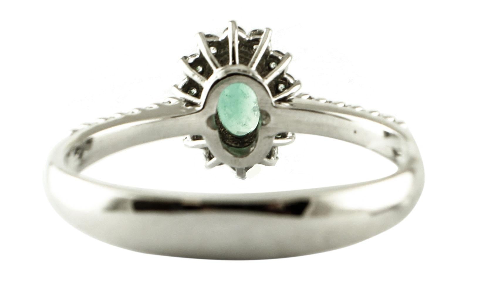 Modern Central Emerald, Diamonds, 18 Karat White Gold Ring