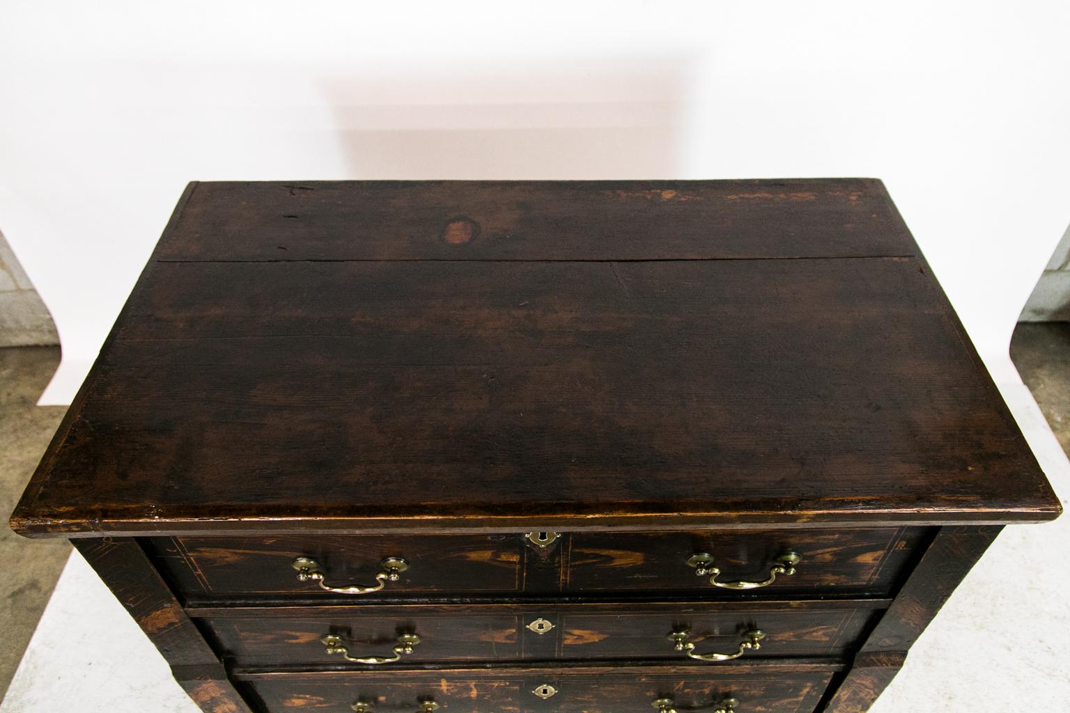 This Central European faux painted chest has a lift top with an old shrinkage crack that has had four later batten braces applied to arrest further shrinkage. There is a lift top on the left inside top. The chest has the original forged steel lock.