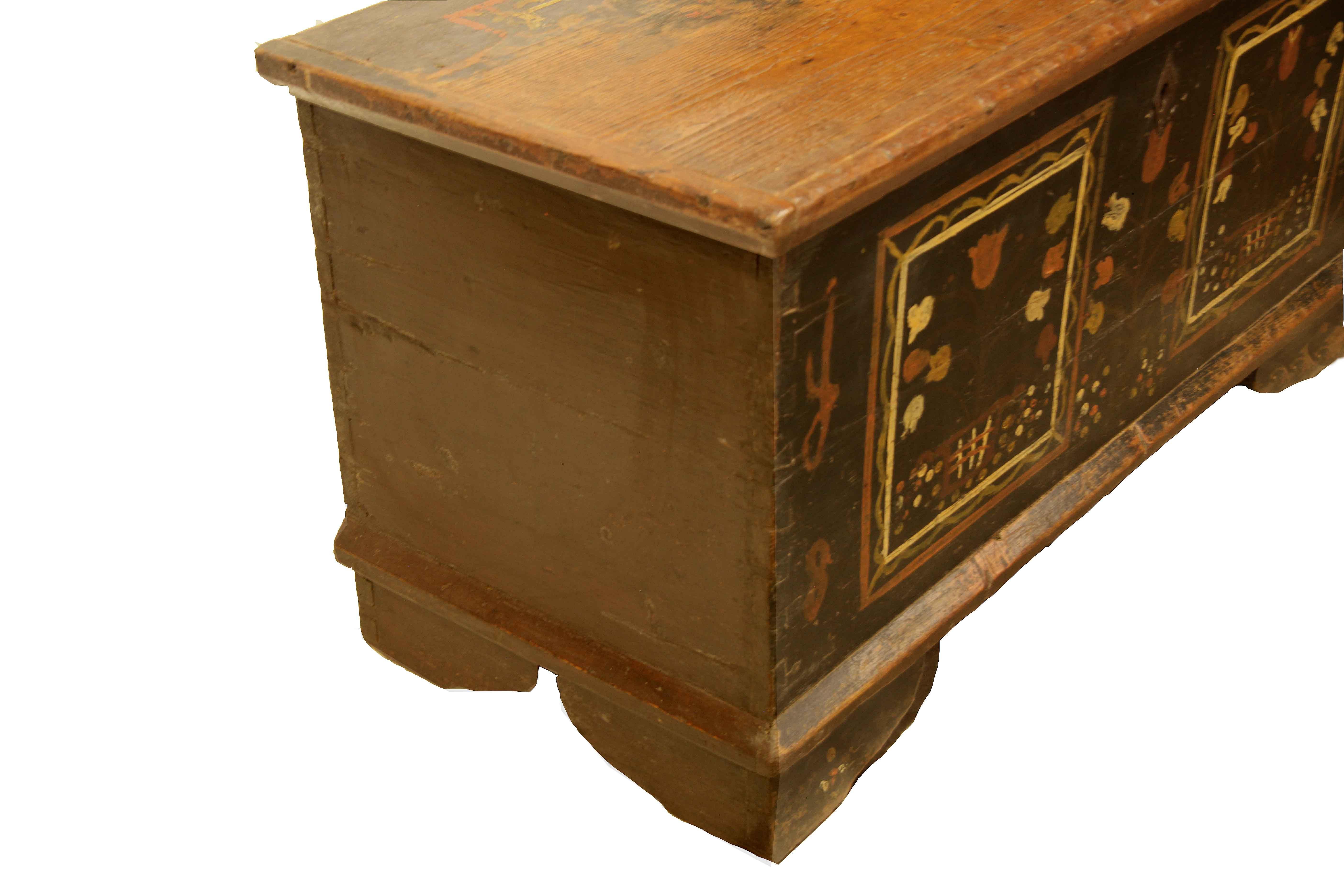Central European painted blanket chest,  the back portion of the top retains remnants of the original paint decoration (similar to the front of the piece), the front portion of the top is worn to the pine grain and has a warm color and patina.  The