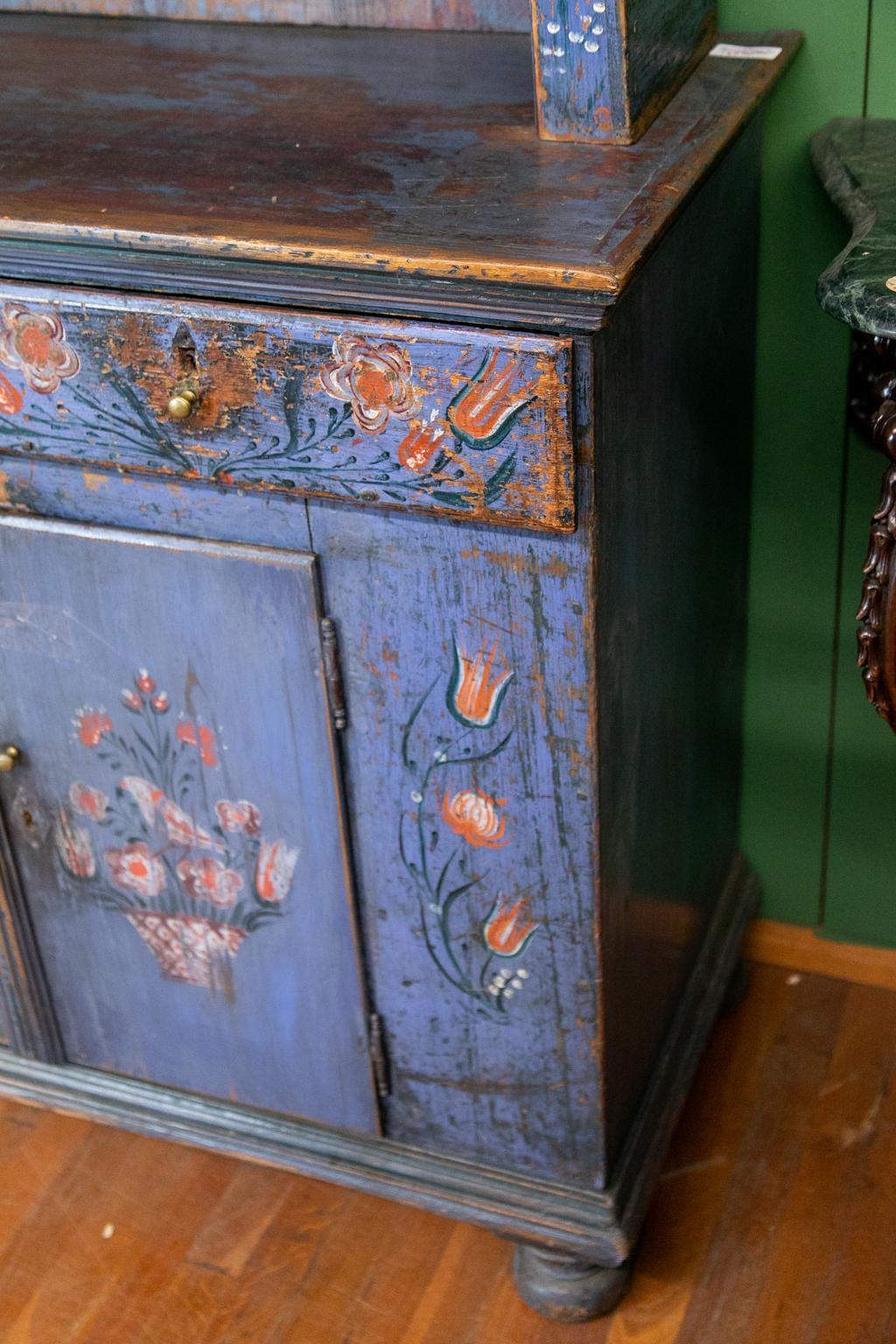 Central European step back cupboard with the original floral painting.