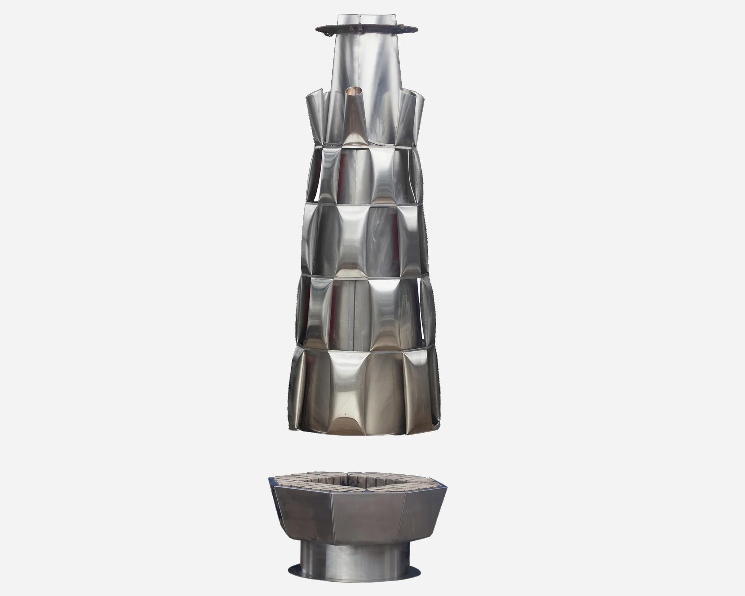 Beautiful fireplace-sculpture by the artist Josef Ciesla, unique piece.

It’s entirely made of stainless steel. Several light bulbs are concealed in each « horn » at the top of the hood, so as to illuminate the ceiling and volumes. It’s in two