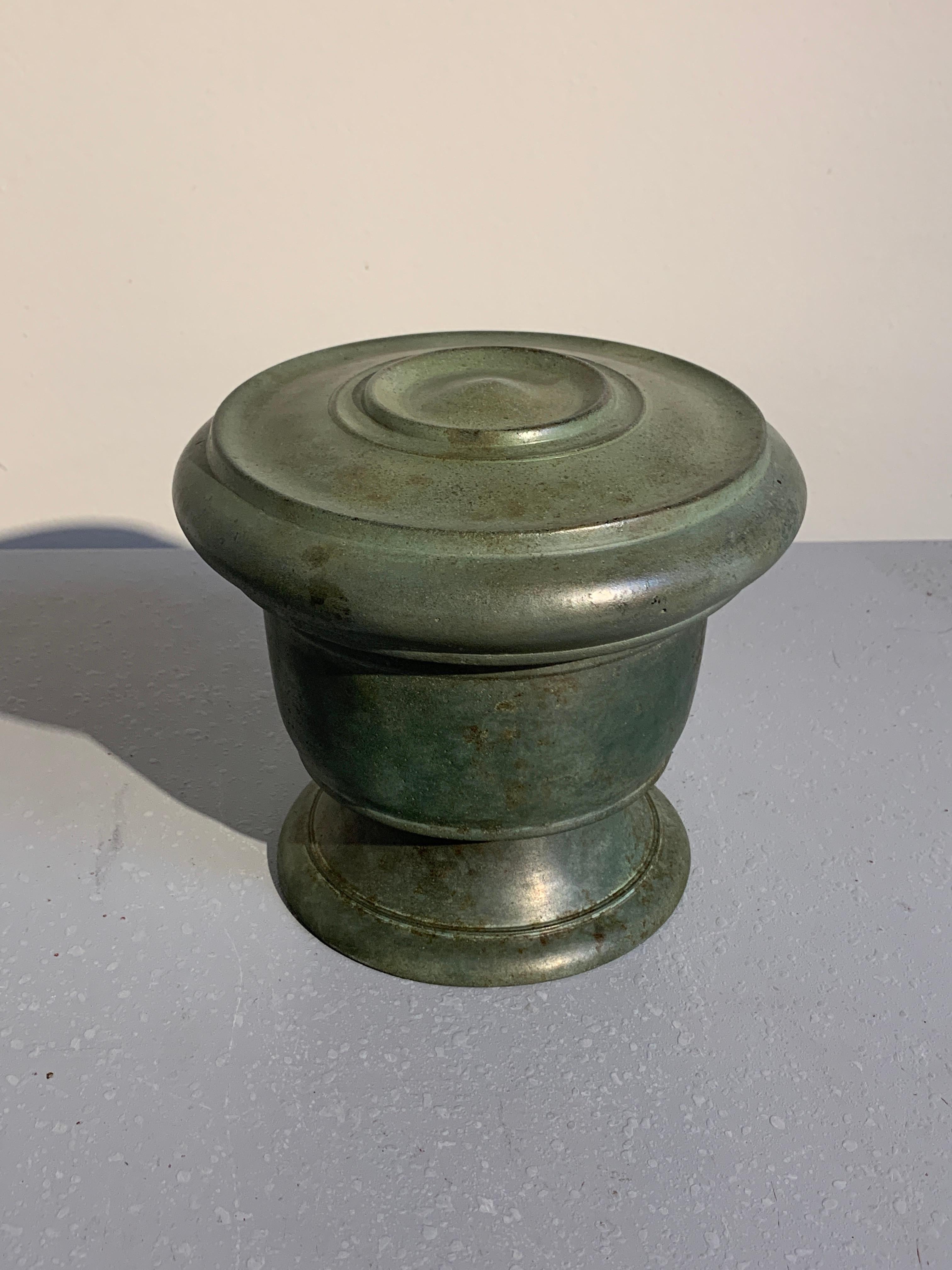 A stunning and rare Javanese bronze footed offering vessel and cover, Central Javanese Period, 8th-10th century.

The ritual offering vessel of elegant form, with a wide splayed foot and squat pedestal supporting the body of the bowl. The deep