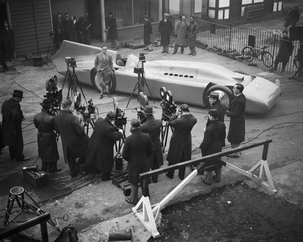 "Bluebird Press Photos" by Central Press

9th January 1935: Cameramen filming British racing driver Malcolm Campbell as he poses with a new Bluebird which he will use in an attempt to break his own land speed record in Daytona, USA.

Unframed
Paper