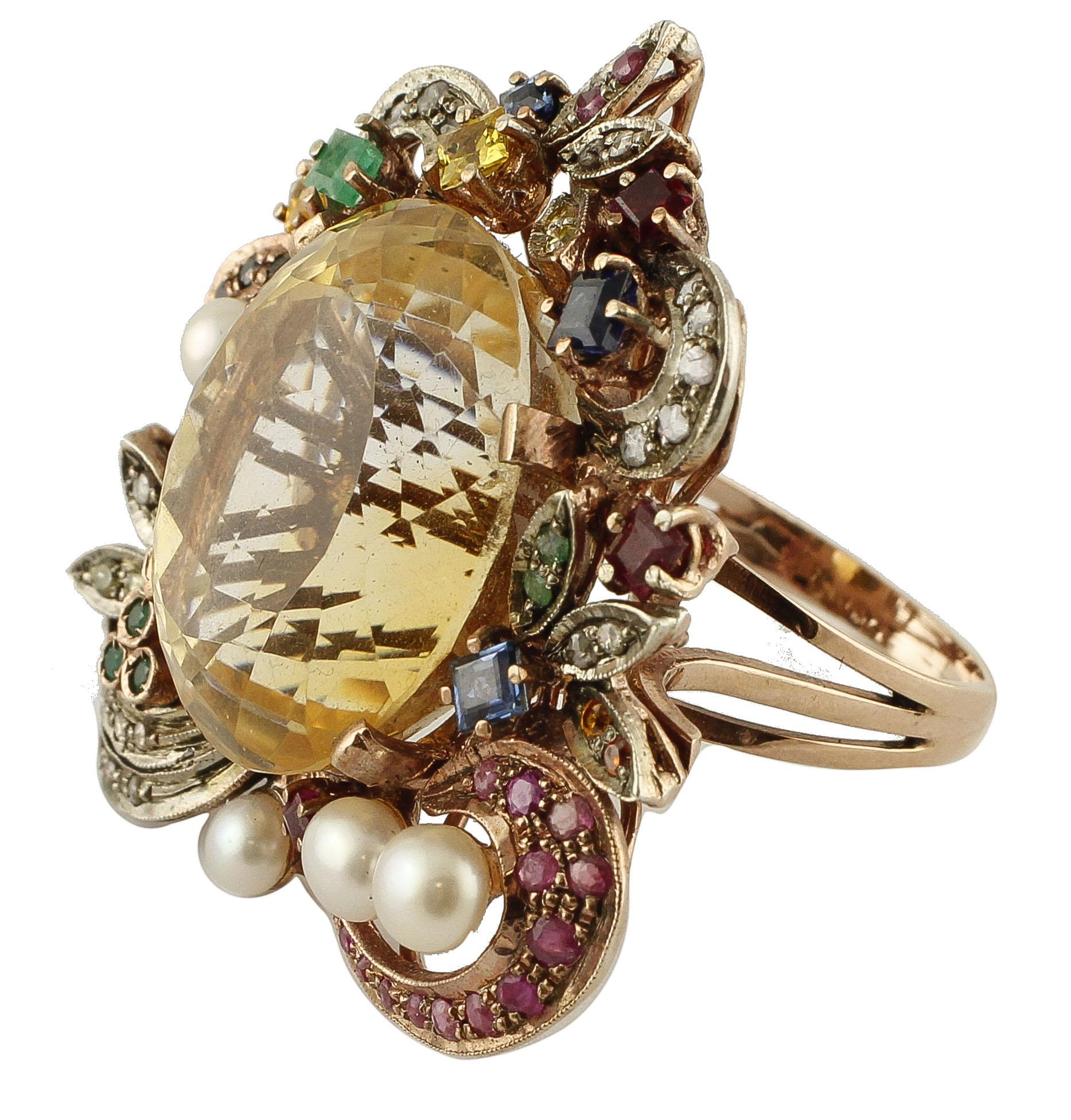 Beautiful retro ring in 9k rose gold and silver structure. The ring is mounted with a big yellow topaz in the centre surrounded by flowery details in gold and silver studded with sapphires, diamond, emeralds, rubies and littlre pearls. 
This ring is