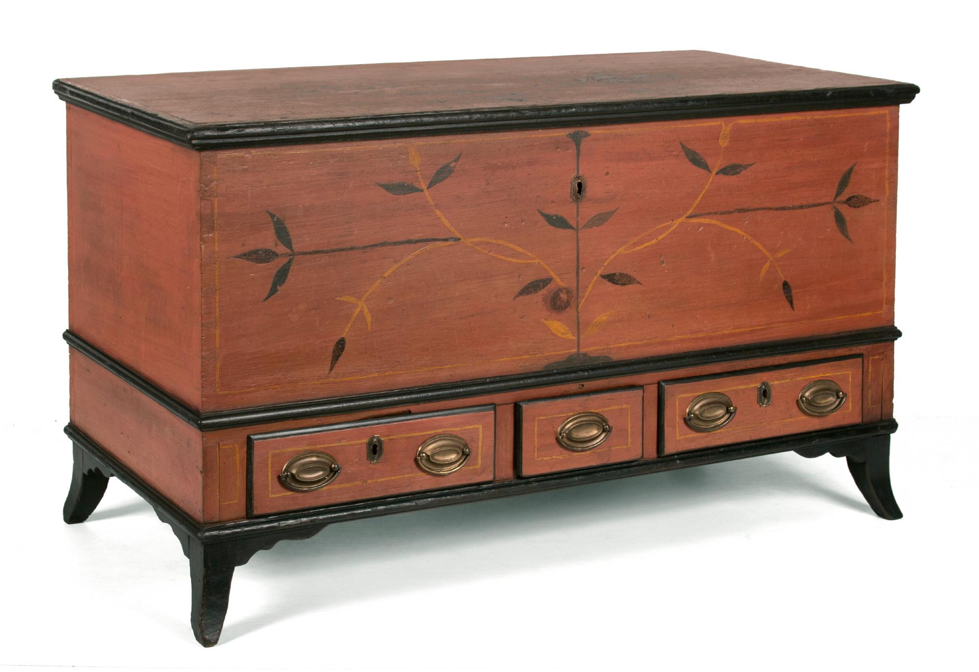 PAINTED, CENTRE COUNTY, PENNSYLVANIA BLANKET CHEST IN SALMON AND BLACK WITH FLORAL DECORATION, 3 DRAWERS, AND APPLIED, SPLAY FEET, circa 1815-1825

Salmon-painted Pennsylvania blanket chest with ebonized molding at the top, waist, and base, and