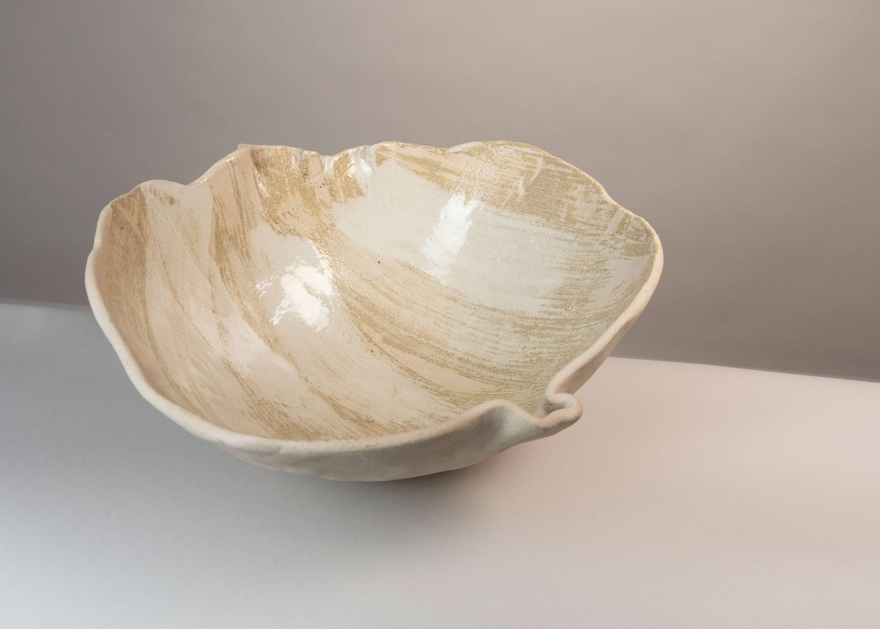 This unique ceramic centrepiece is made of Bavarian Porcelain. Exceptionally it contains Chamotte which gives it both the rough to the touch areas, like sand, as well a the soft smooth and fresh aspect.

With this piece the artist continues her