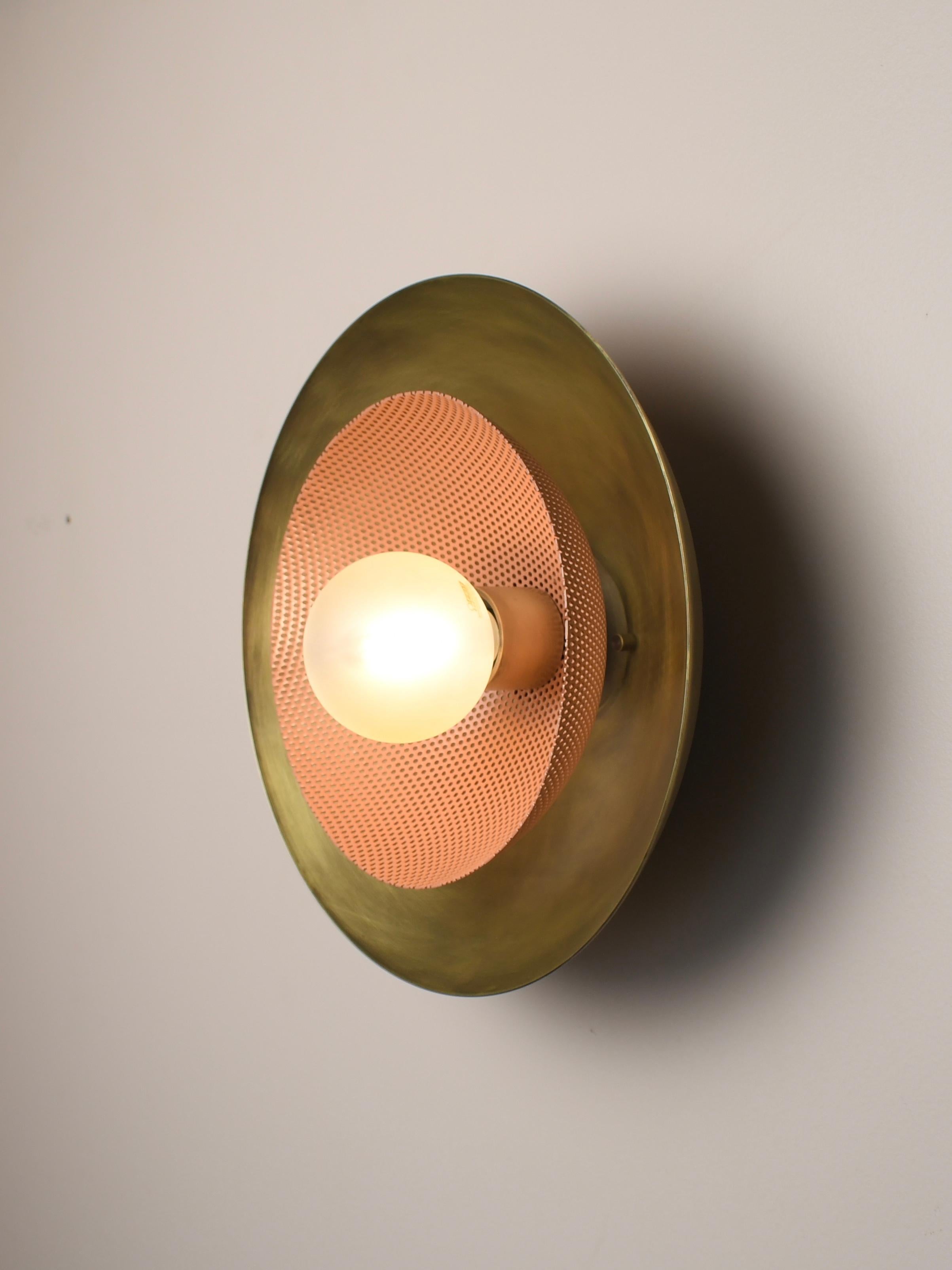 The centric wall sconce is a stately take on French modernism, featuring a spun metal mesh shade nestled into a large solid brass bowl. Part of our axial family of products, the centric wall sconce is a substantial, handsome piece that works well in